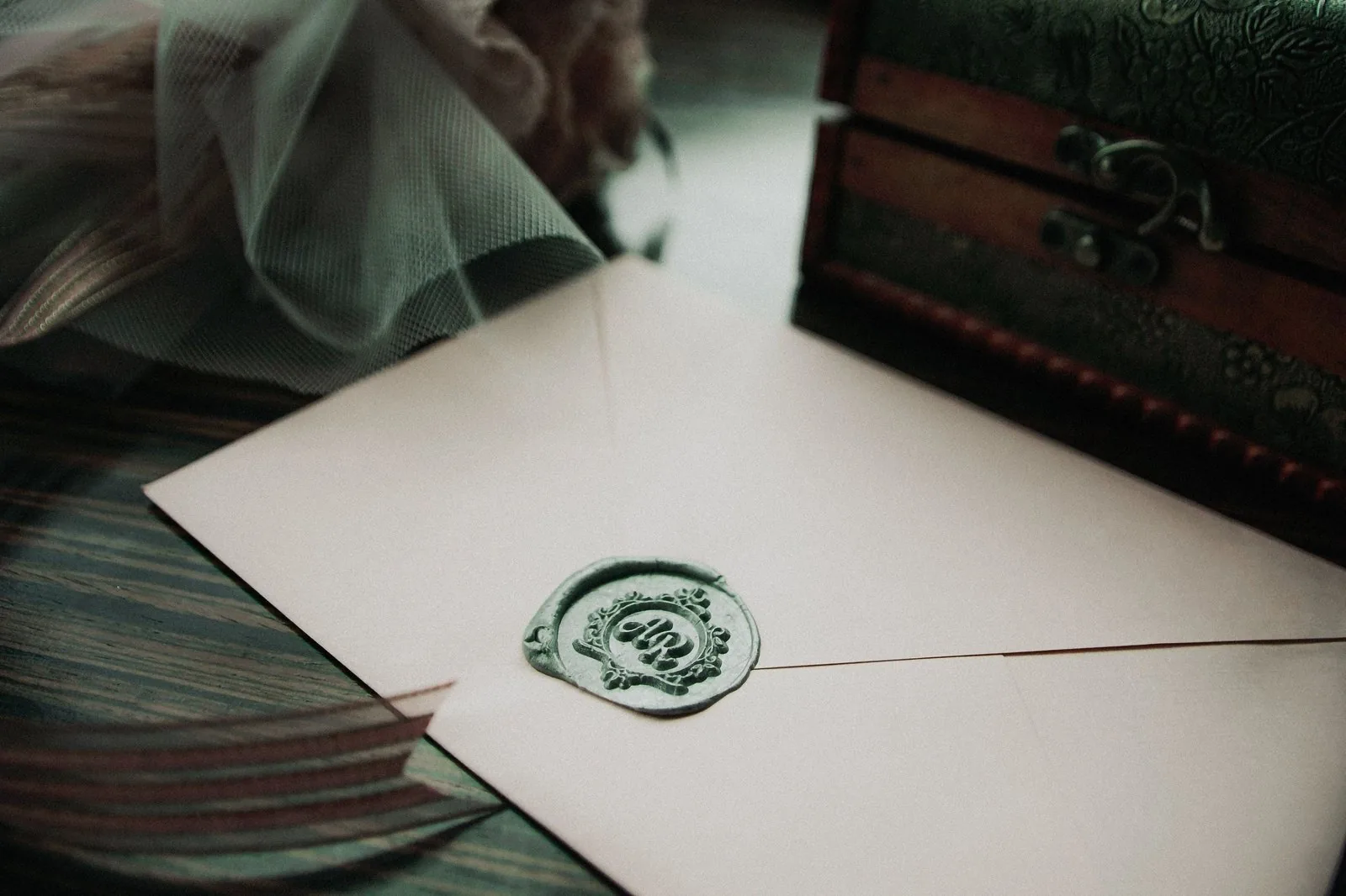 Back flap of a wedding invitation envelope closed with a pressed wax seal
