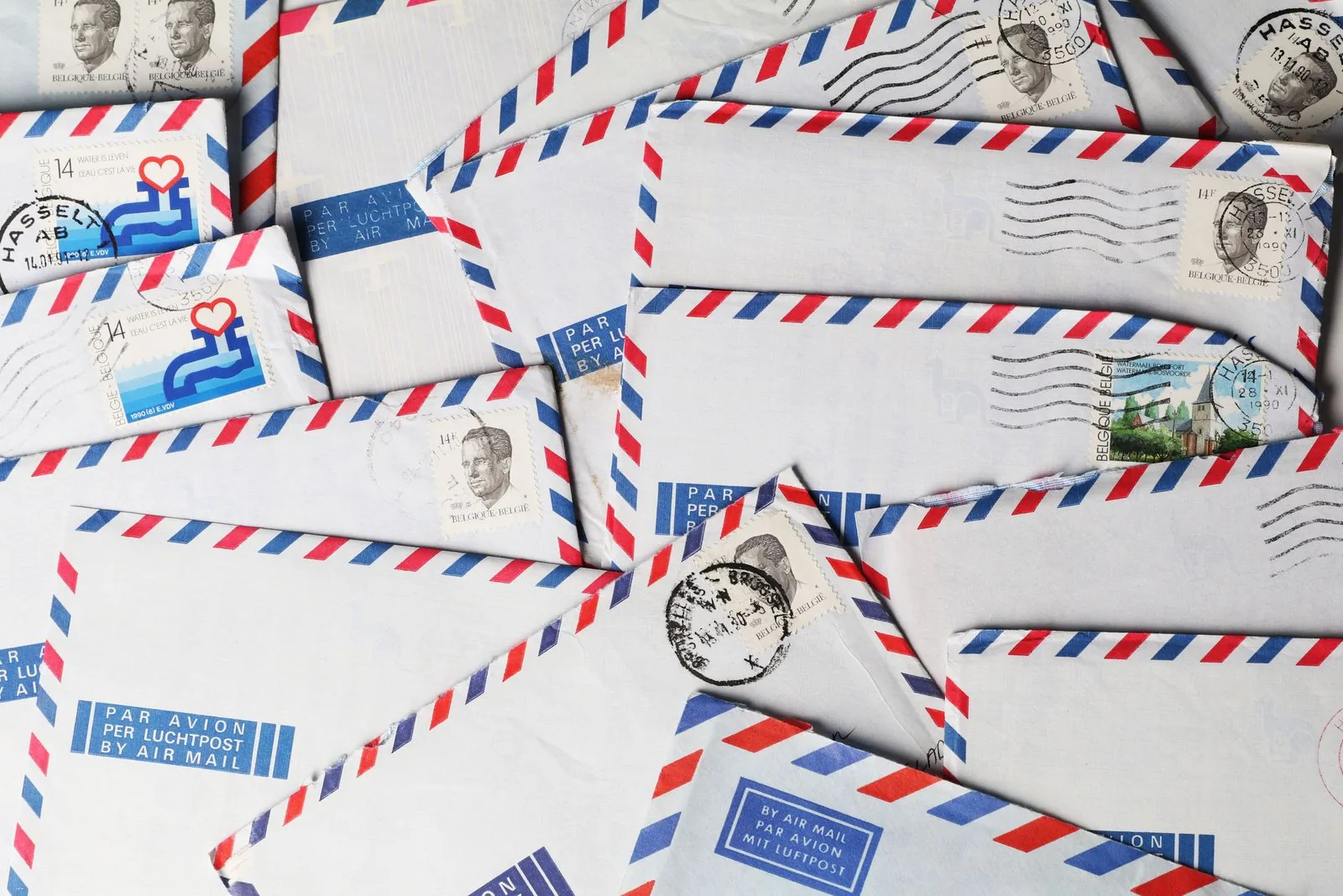 Stamped envelopes with postmarks spread out ready for mailing
