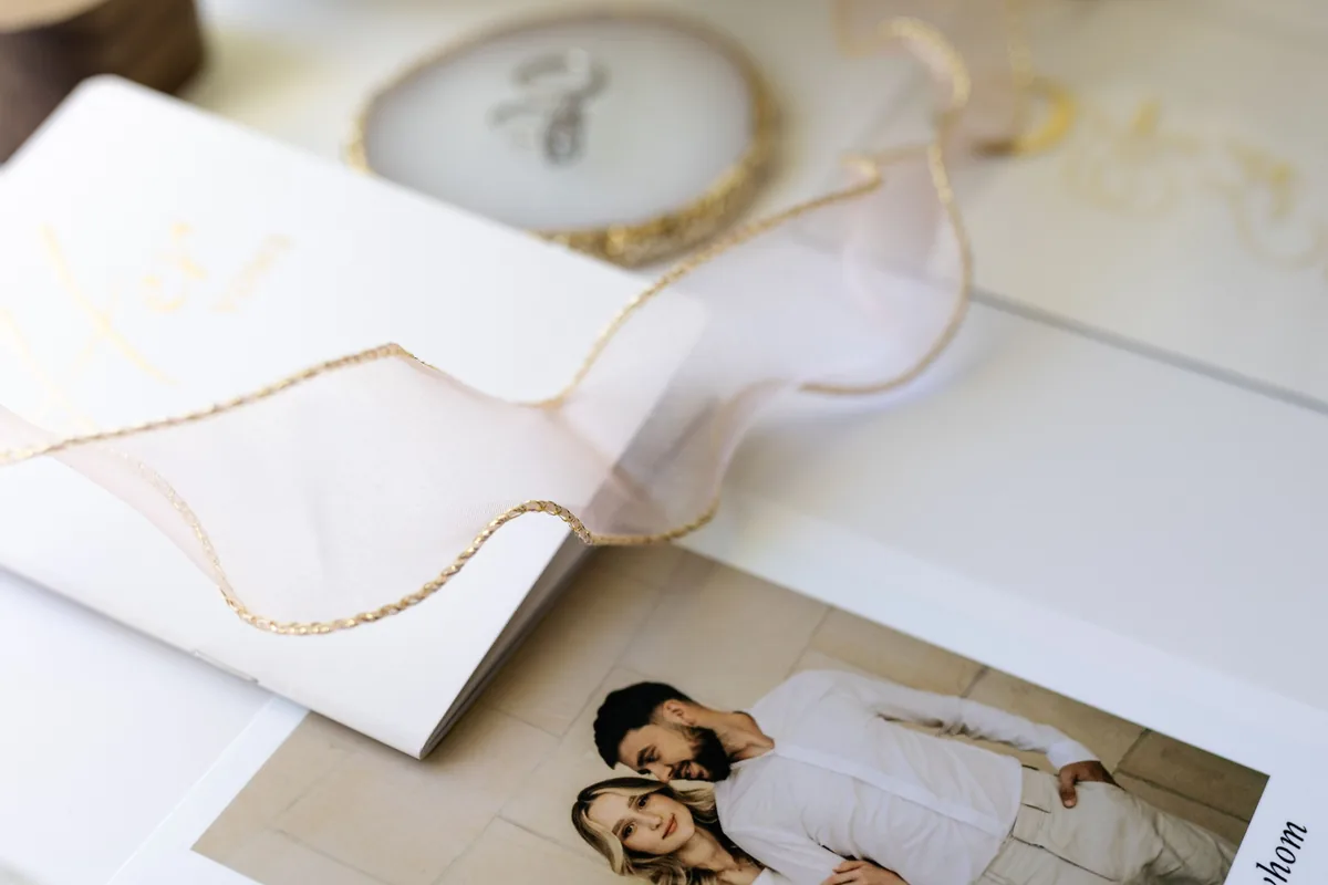 Wedding vow book with a printed photo card and gold-edged ribbon, part of a complete wedding stationery suite