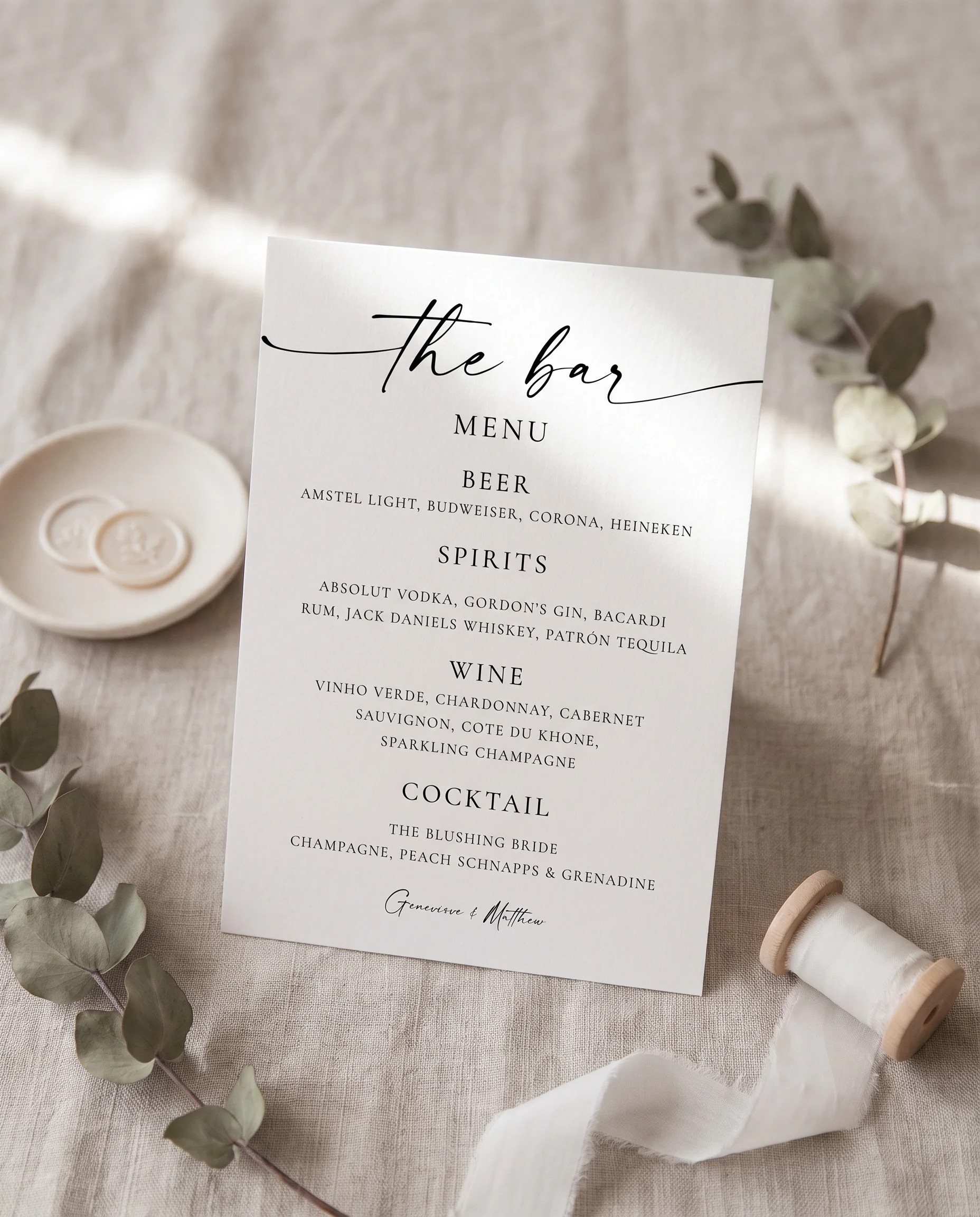 Arcadia — bar menu displayed upright in a styled setting under soft natural light with a slight overhead angle, wedding bar sign.
