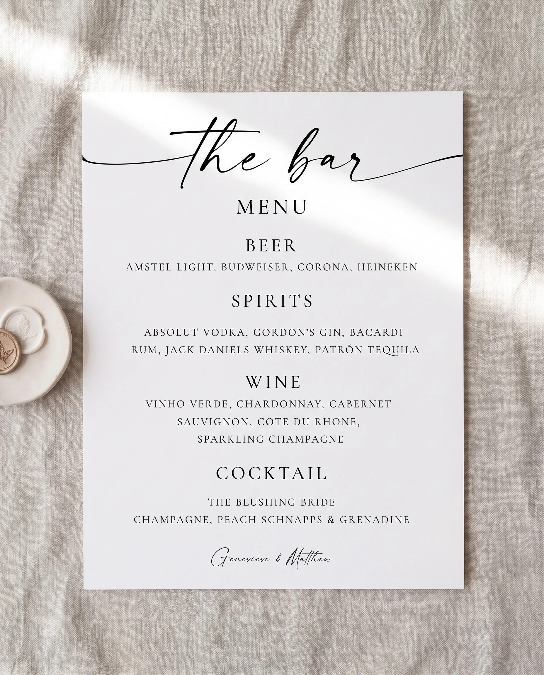 Arcadia — bar menu page lying flat under soft natural light with a slight overhead angle, wedding bar menu