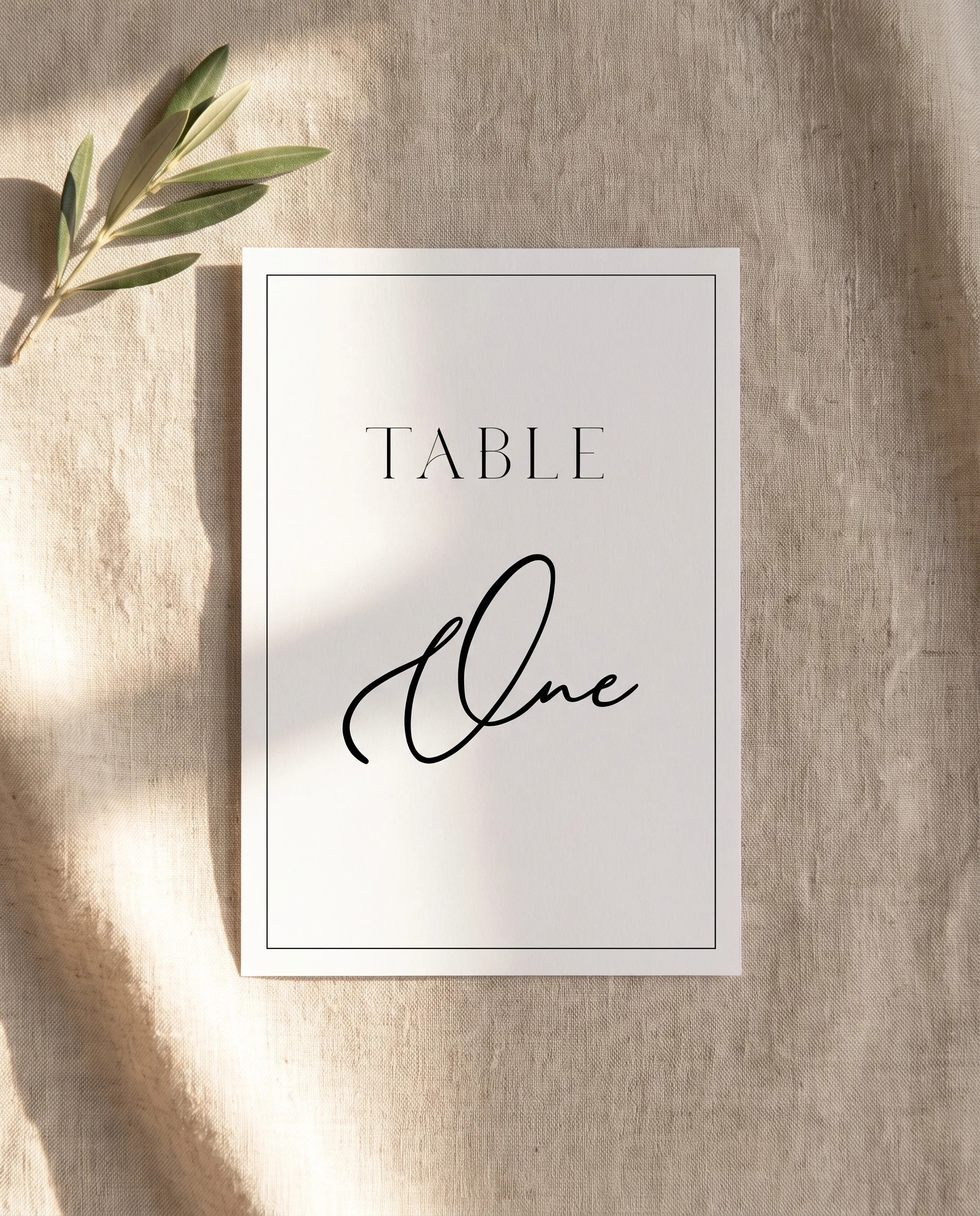 Aurelian wedding table number — single card shown flat under soft natural light with a slight overhead angle, wedding table numbers