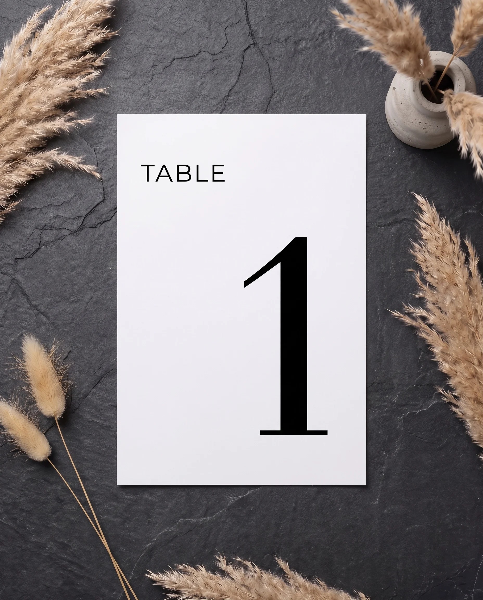 Barline wedding table number — single sheet shown flat under soft overhead light on premium editorial paper, wedding table numbers