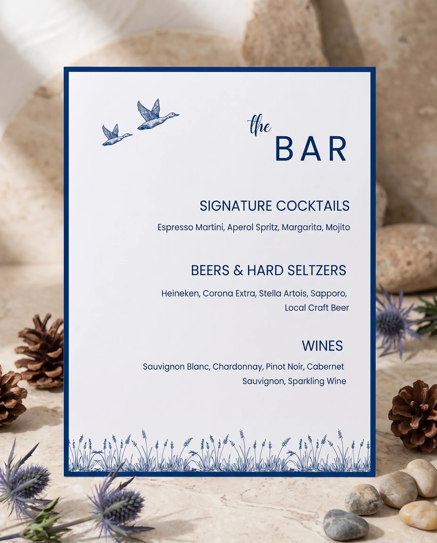 Blue Range — bar menu page displayed upright in a styled setting under soft natural light, wedding bar sign