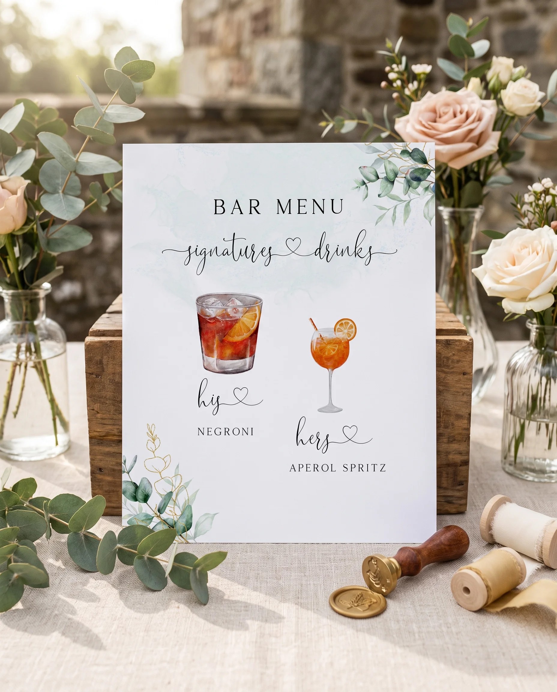 Eucalyptus Gold — bar menu page displayed upright in a styled setting under soft natural light, wedding bar sign.