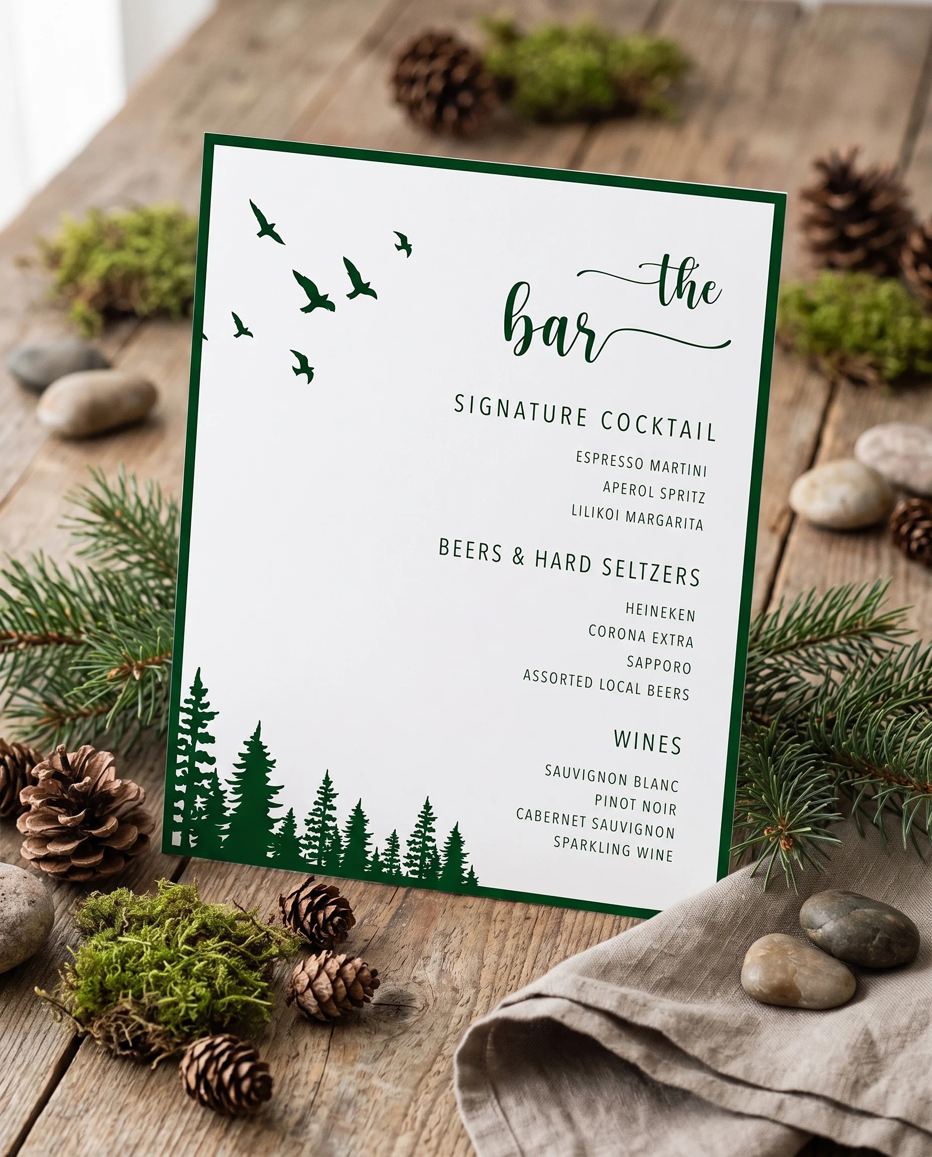 Evergreen Star — bar menu displayed upright on premium editorial paper in soft natural light, wedding bar sign.