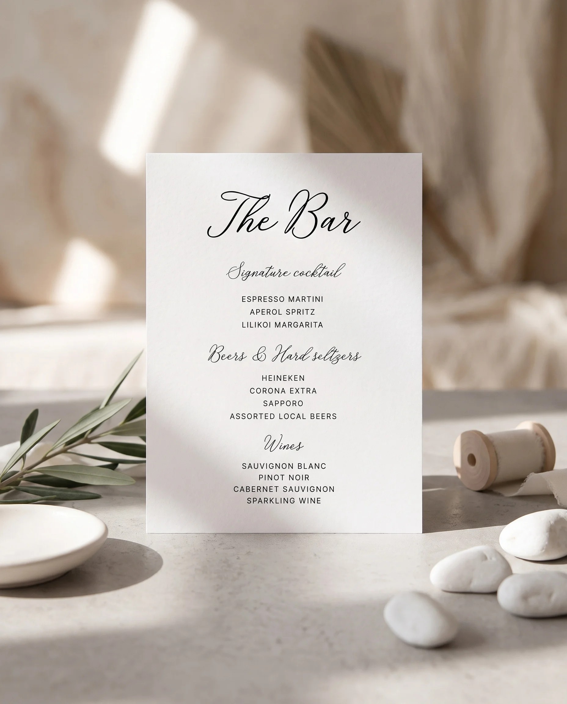 Lyris — bar menu page displayed upright under soft natural light with a slight overhead angle, wedding bar sign.