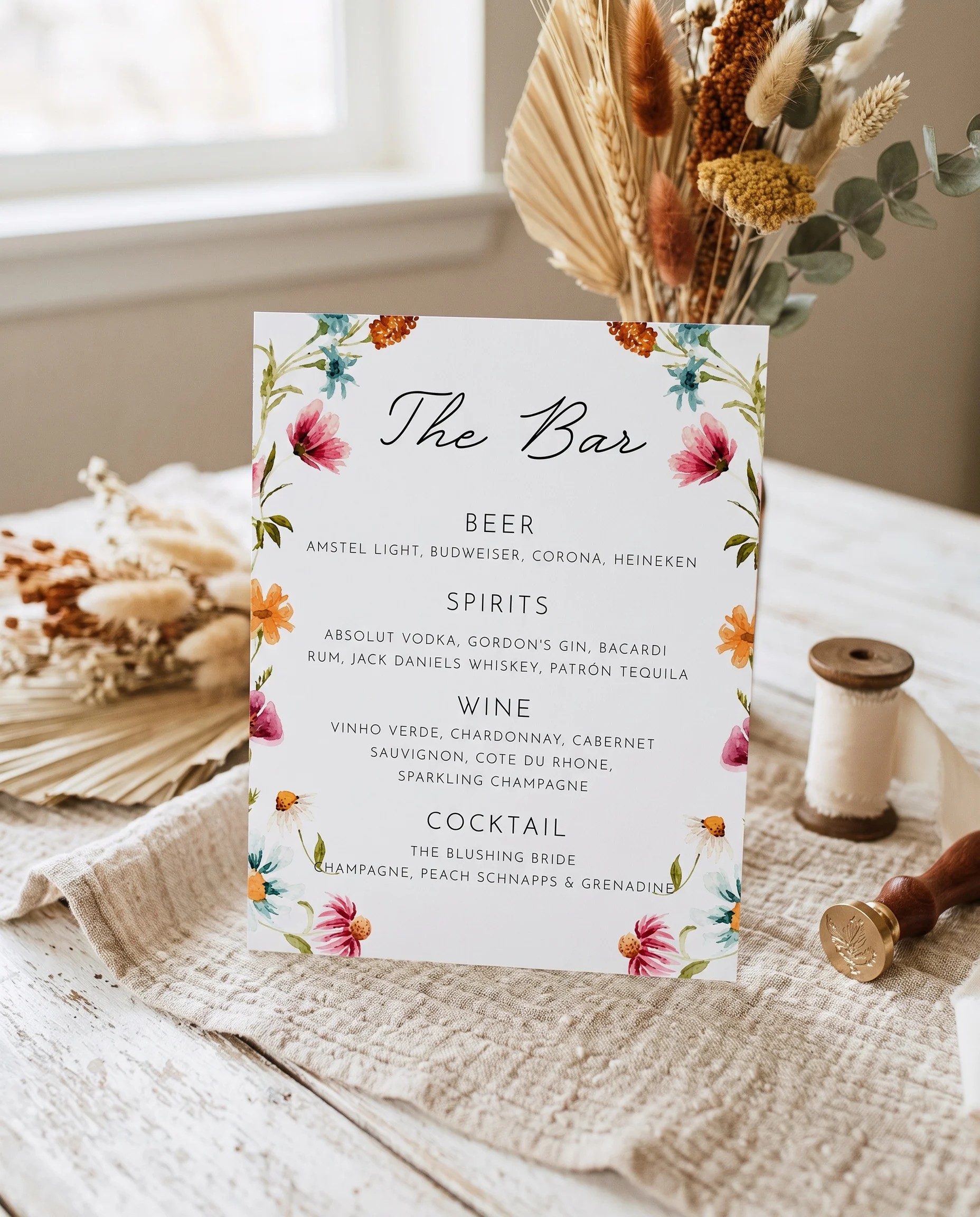 Meadow Ring — bar menu displayed upright in a styled setting under soft natural light, wedding bar sign.