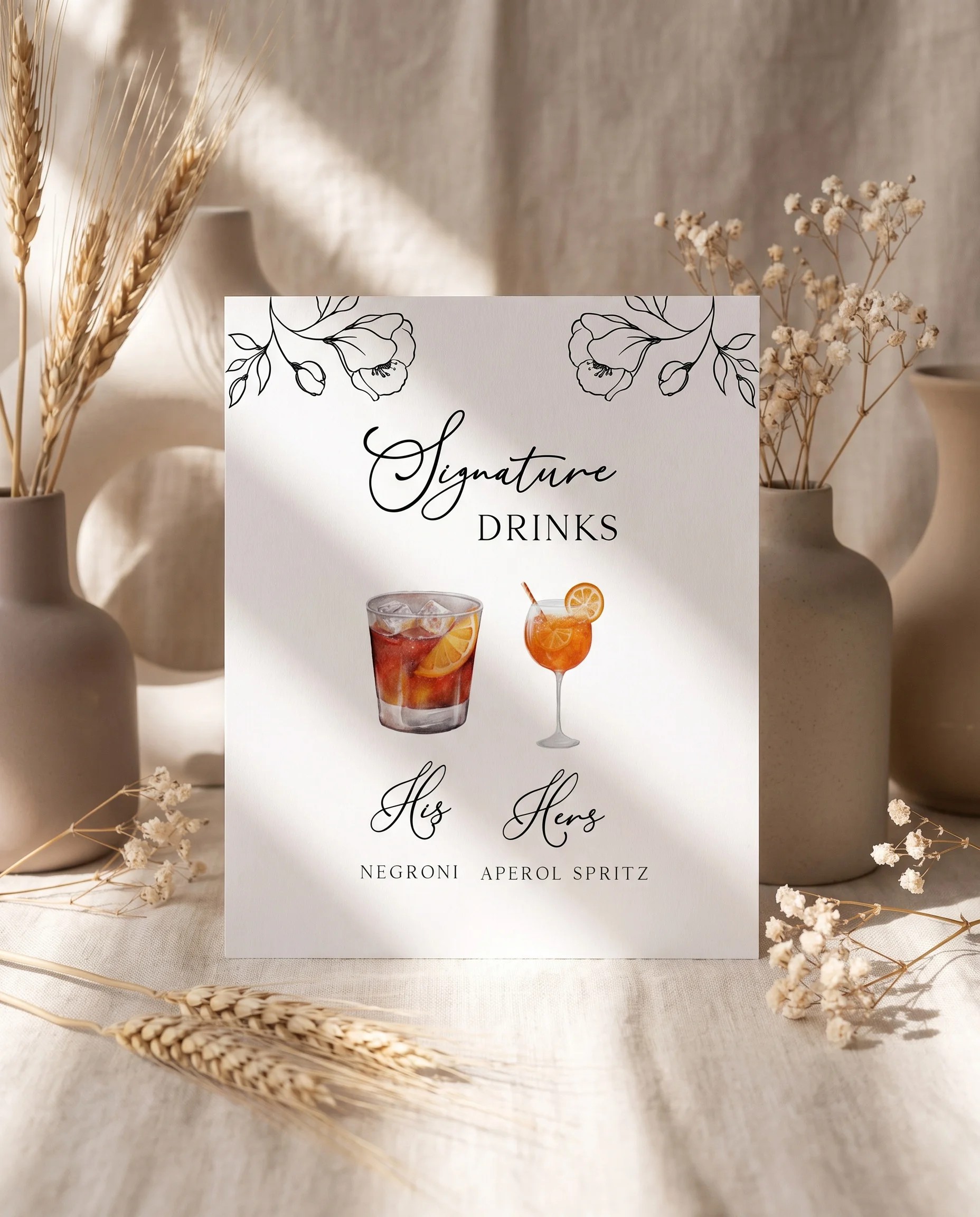 Meadow Sprig — bar menu page displayed upright in a styled setting under soft natural light, wedding bar sign.