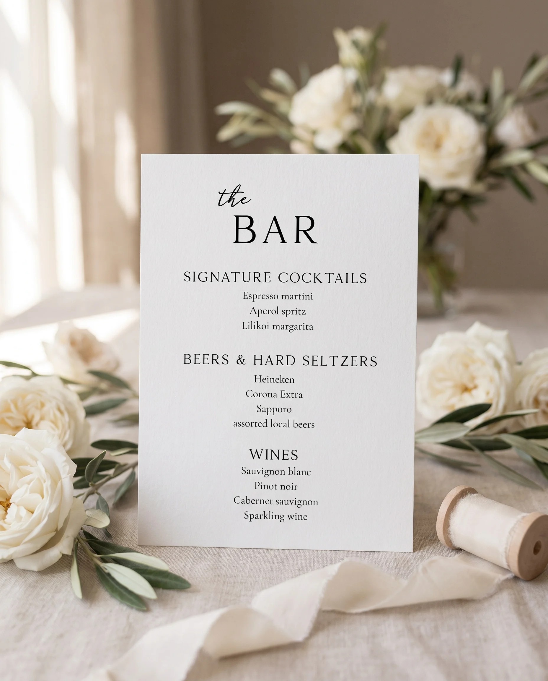 Quiet Line — bar menu page displayed upright in a styled setting under soft natural light, wedding bar sign.