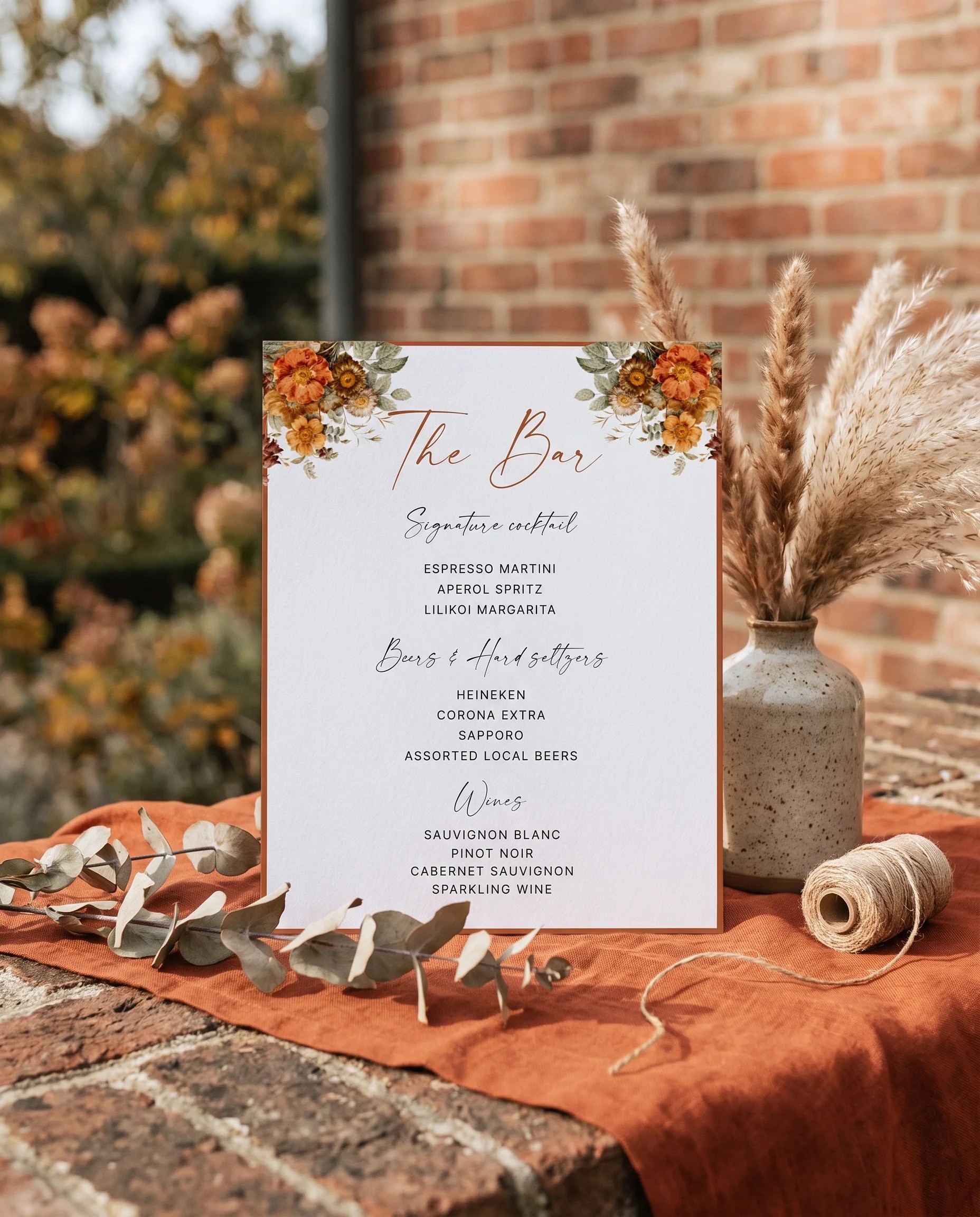 Terracotta Crown — bar menu page displayed upright in a styled setting under soft natural light, wedding bar sign.