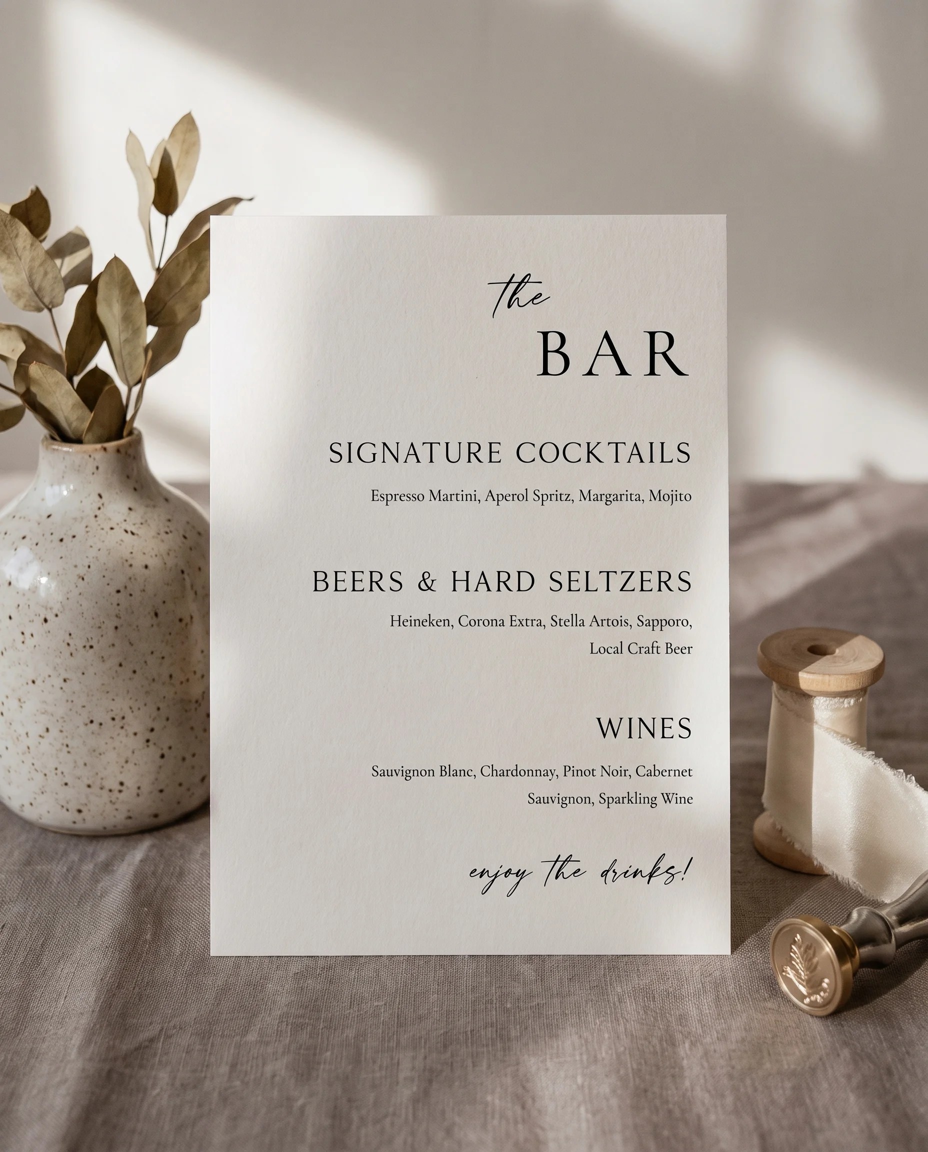 Tonal Reply — bar menu displayed upright in a styled setting under soft natural light with slight overhead angle, wedding bar sign.