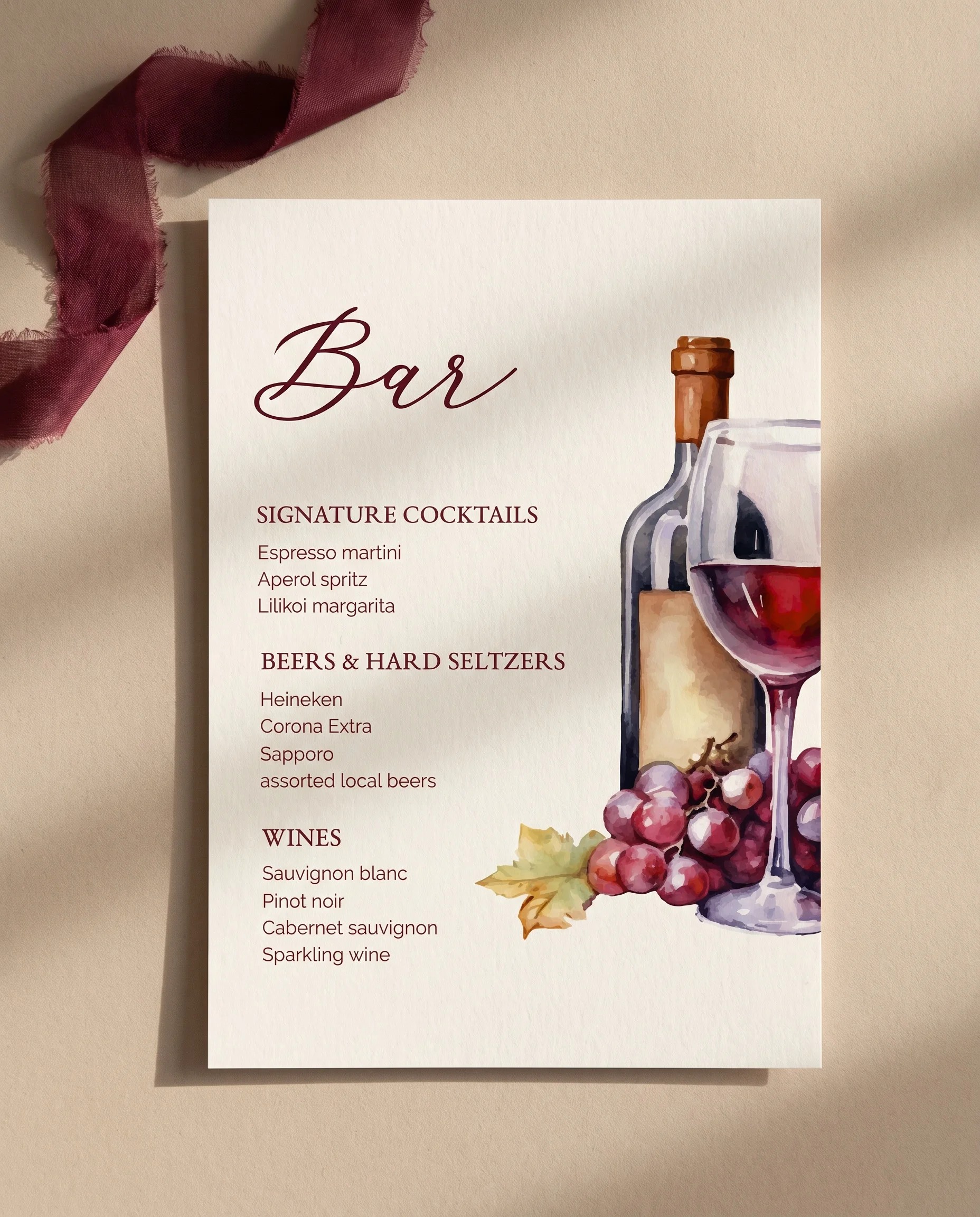 Claret Vine — flat lay of the single-page bar menu on premium paper under soft overhead light, wedding bar menu.