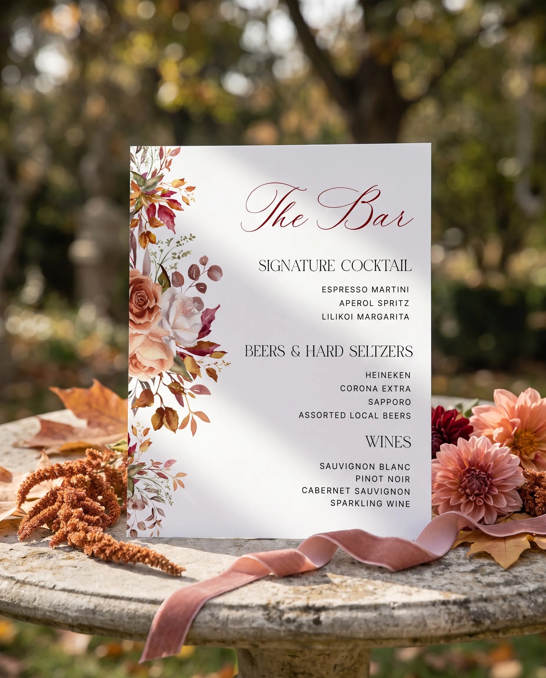 Autumn Blush — bar menu page displayed upright in a styled setting under soft natural light, slight overhead angle, wedding bar sign.