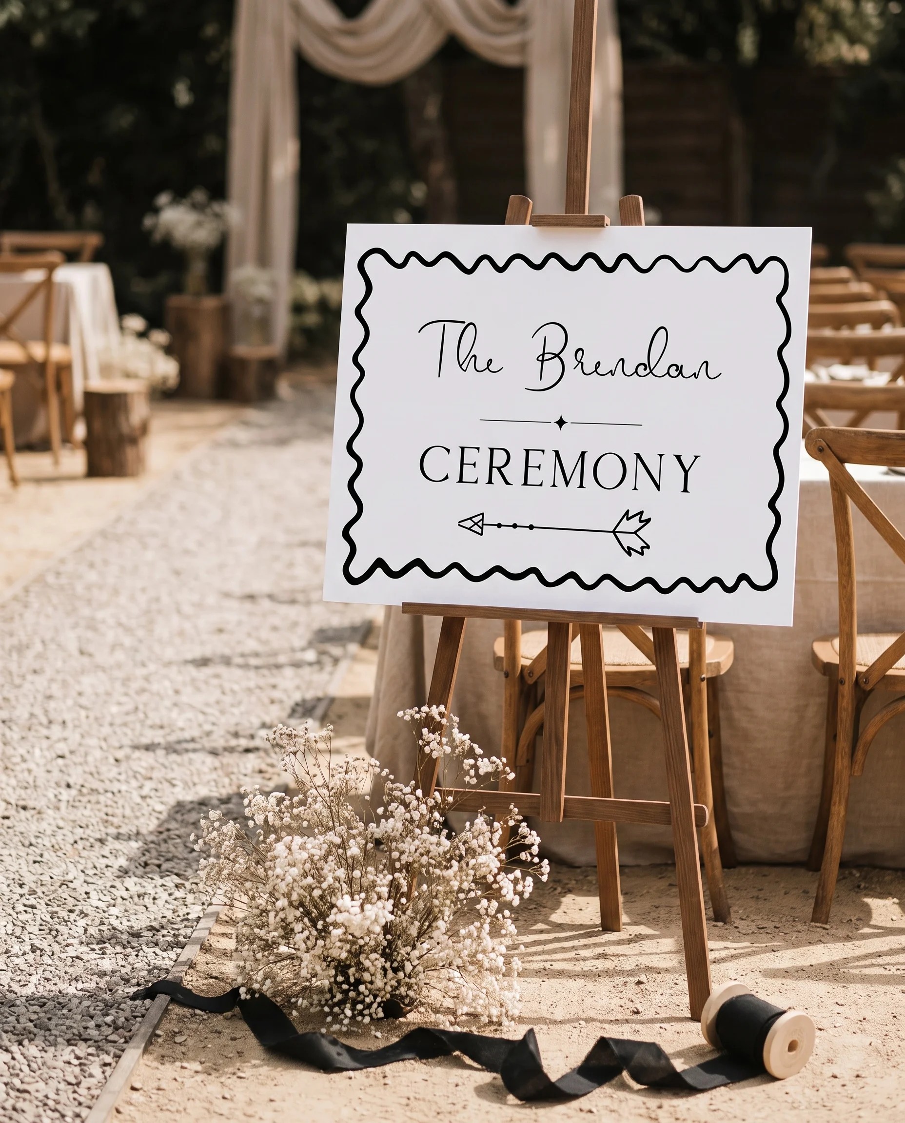 Sketchbook Bow wedding ceremony sign — shown at a wedding ceremony setting under soft natural light, unplugged ceremony sign.