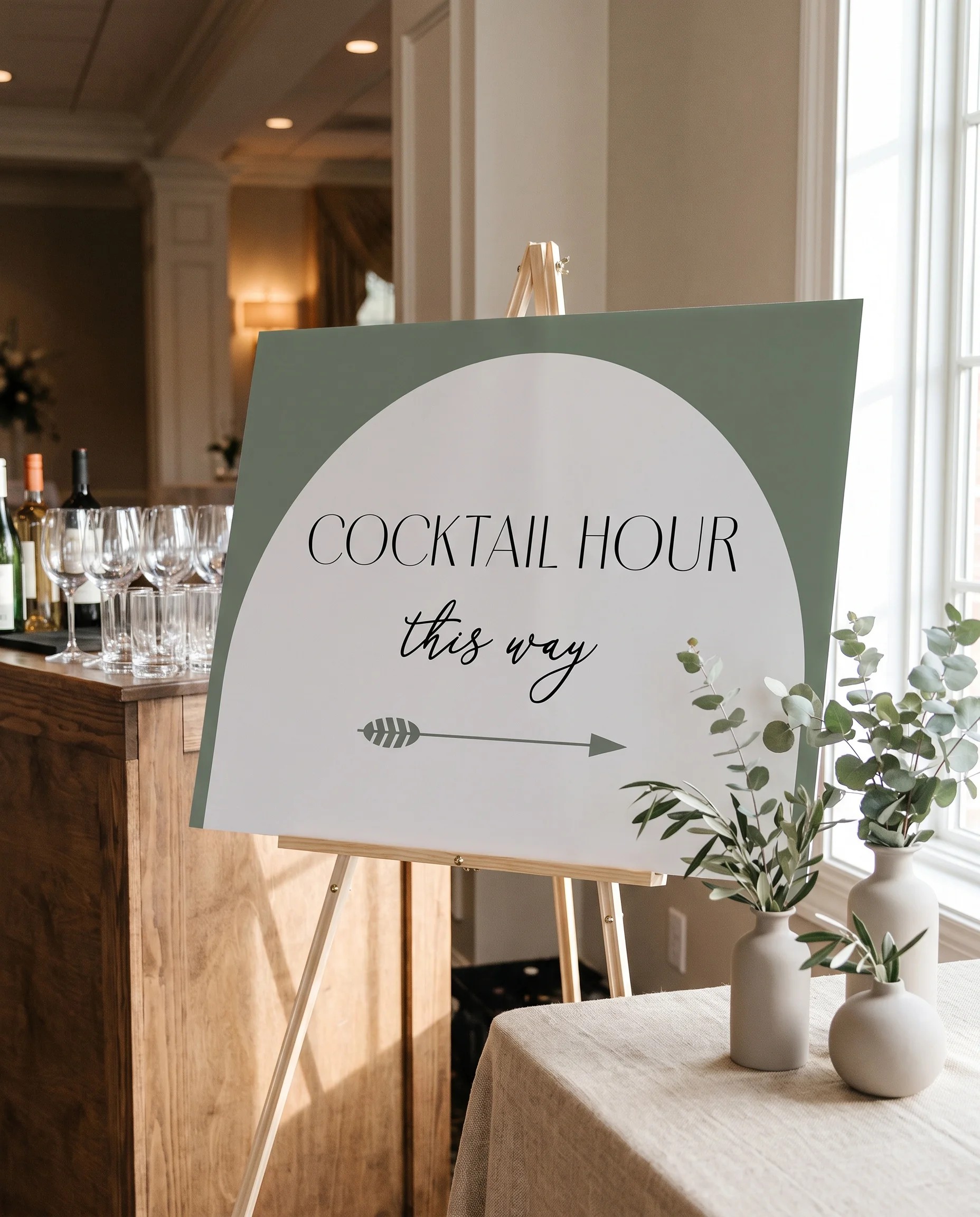 Arc Vale wedding cocktail hour sign — shown beside a drinks station under soft natural light, cocktail hour sign.