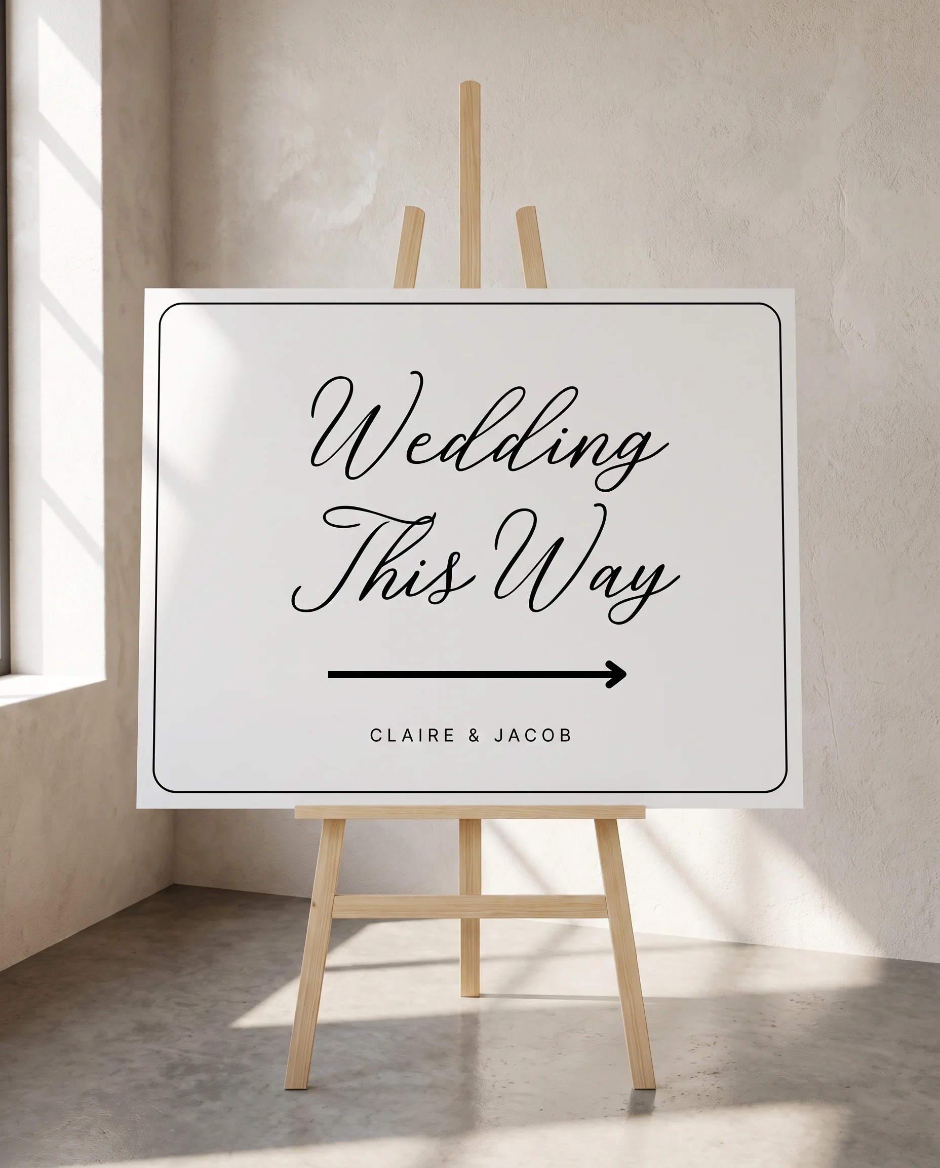 Lyris wedding directional sign — displayed on an easel under soft natural light with a slight overhead angle, wedding signs