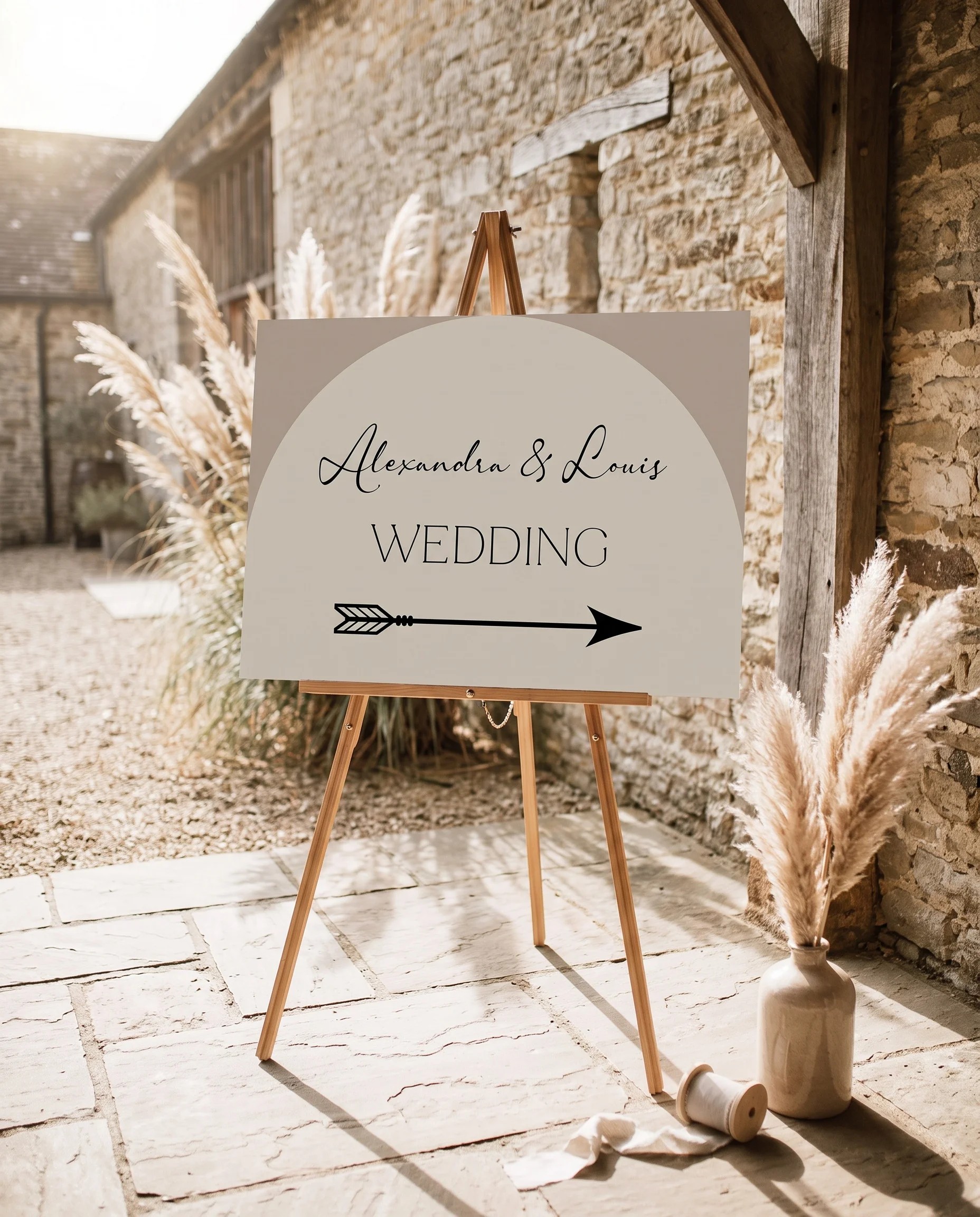 Tassel Arc wedding directional sign — displayed in a wedding venue setting under soft natural light at a slight overhead angle, wedding signage