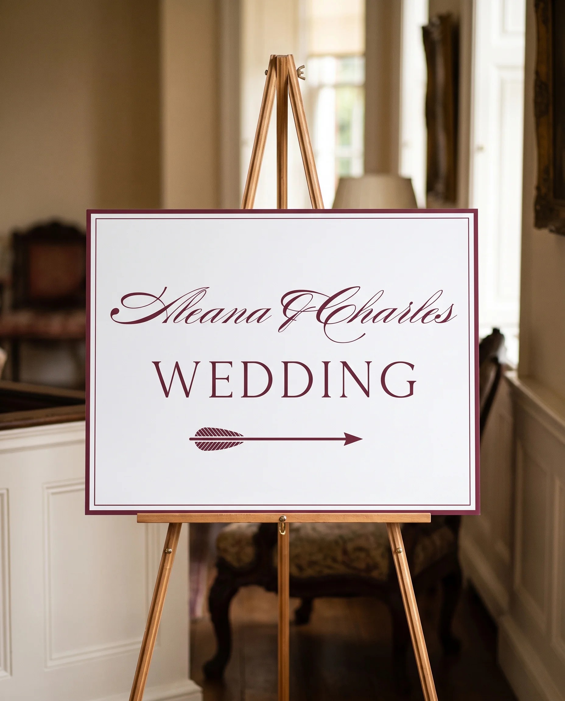 Claret Filigree wedding directional sign — displayed on an easel under soft natural light at a slight overhead angle, wedding signs.