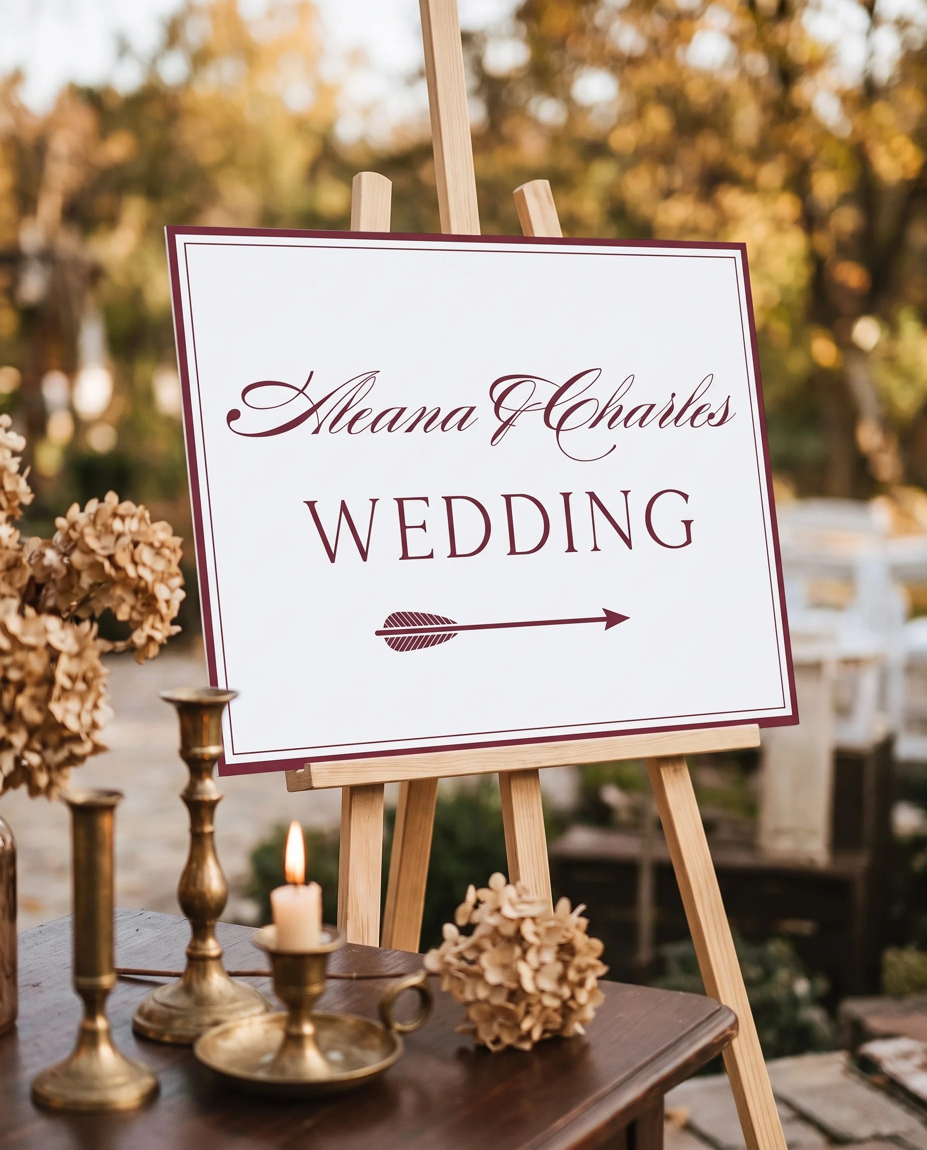 Claret Filigree wedding directional sign — displayed in a wedding venue setting under soft natural light with a slight overhead angle, premium editorial wedding signage.