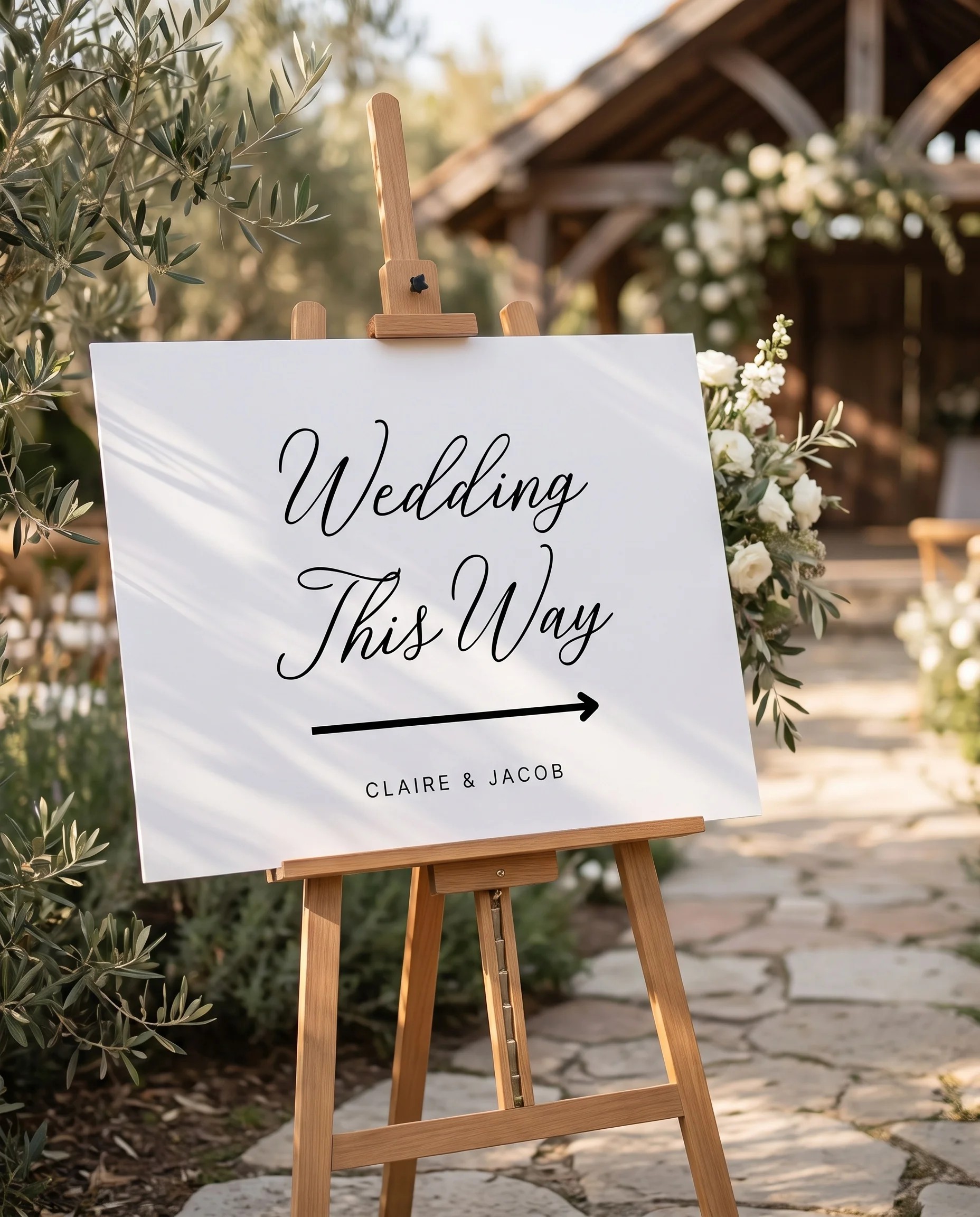 Lyris wedding directional sign — displayed in a wedding venue setting under soft natural light with a slight overhead angle, wedding signage