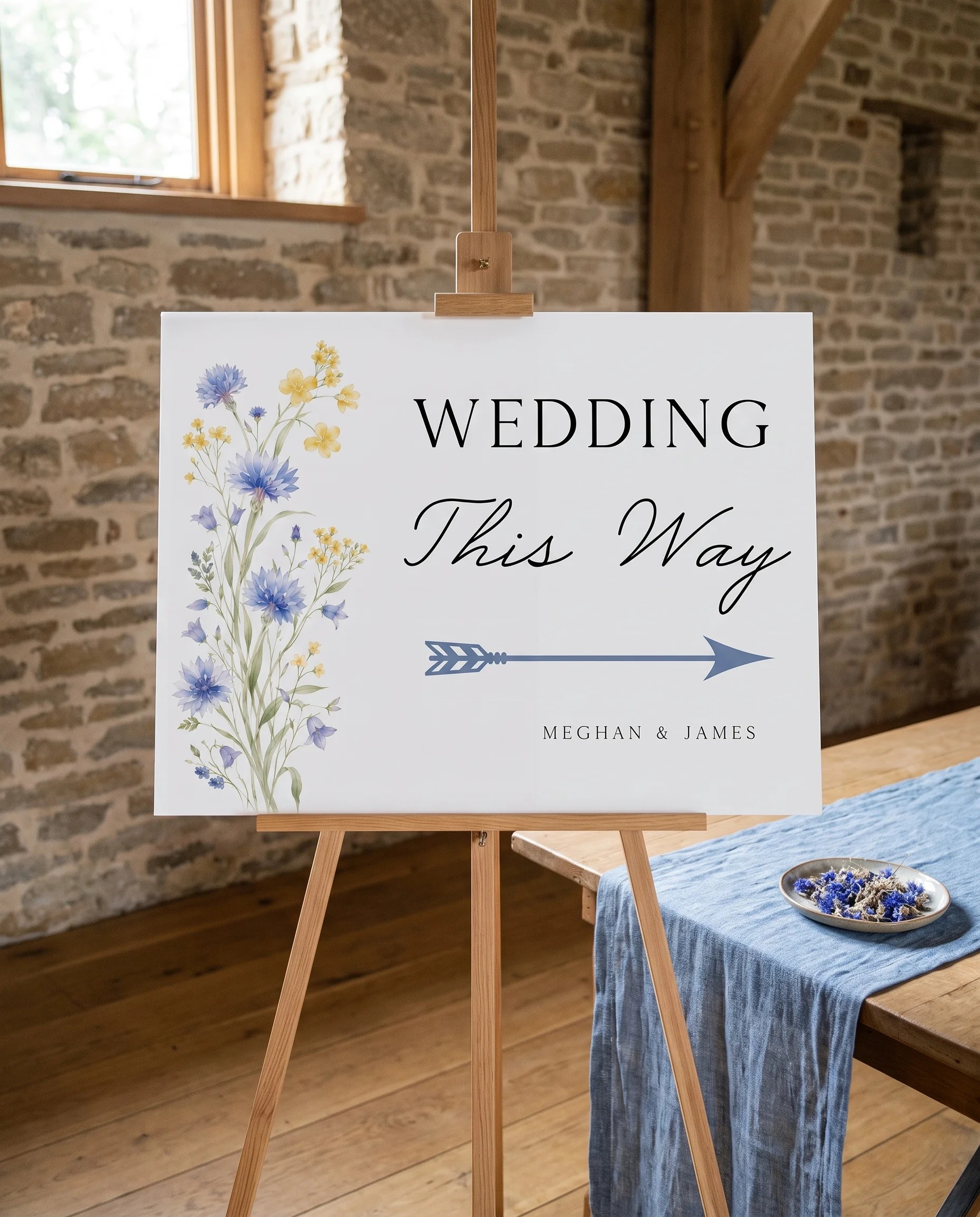 Cornflower wedding directional sign — displayed on an easel under soft natural light with a slight overhead angle, wedding signs
