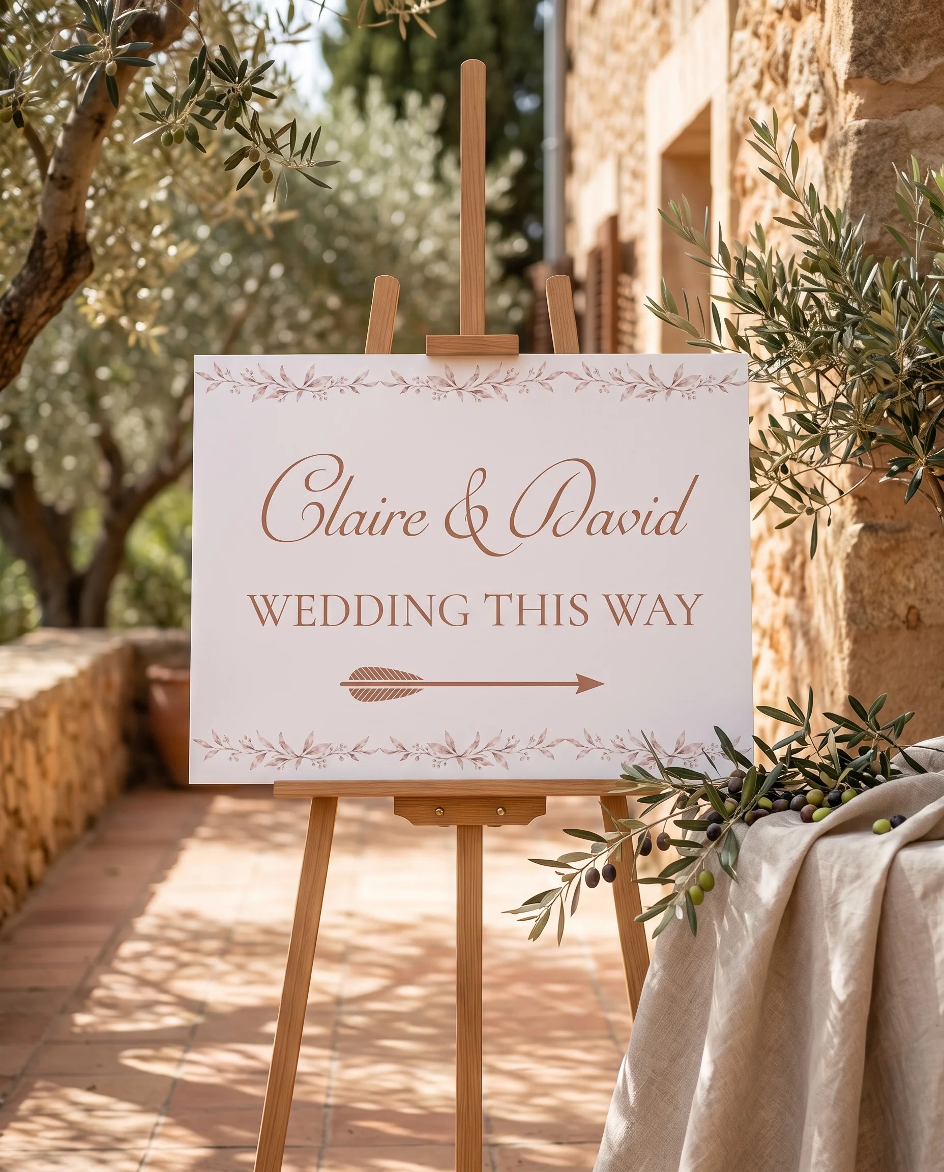 Sepia Sprig wedding directional sign — displayed on an easel under soft natural light at a slight overhead angle, wedding signs