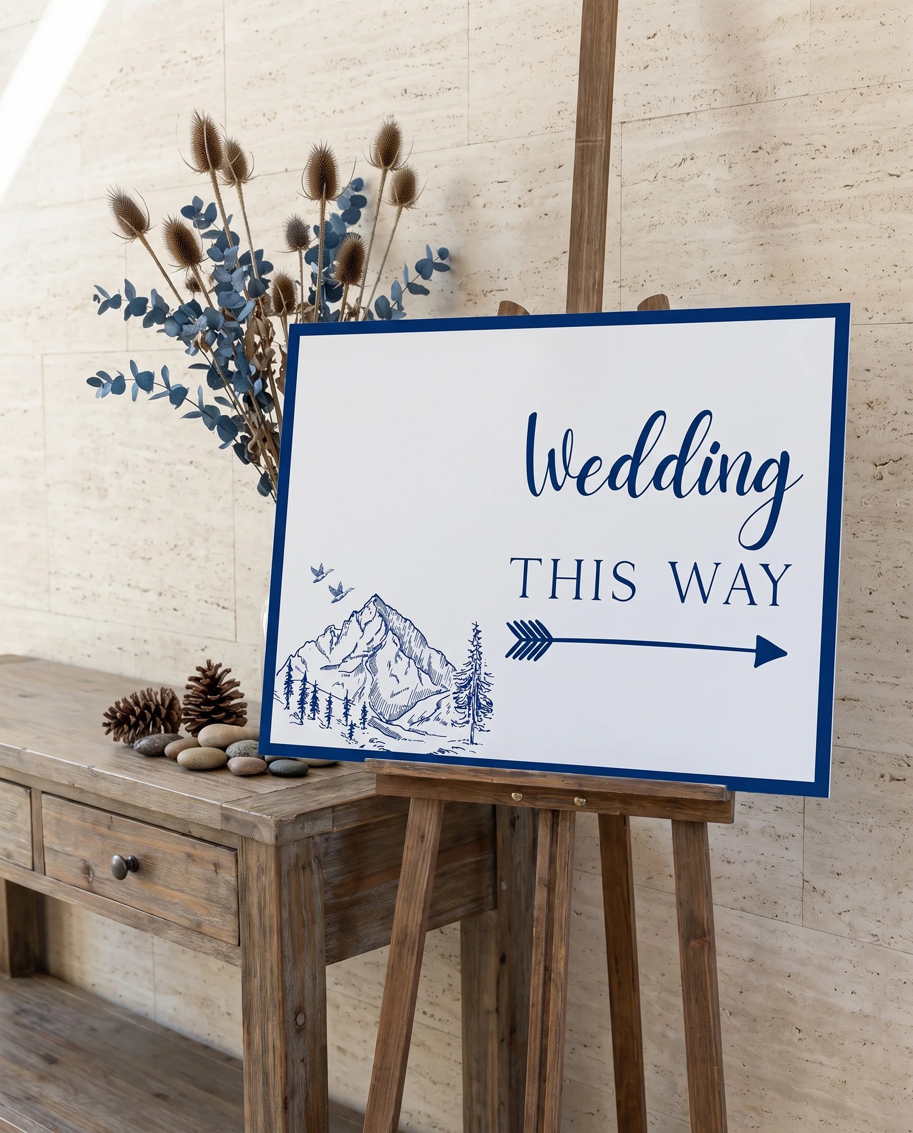 Blue Range wedding directional sign — shown beside furniture for scale on premium editorial paper in soft natural light, printable wedding signs.