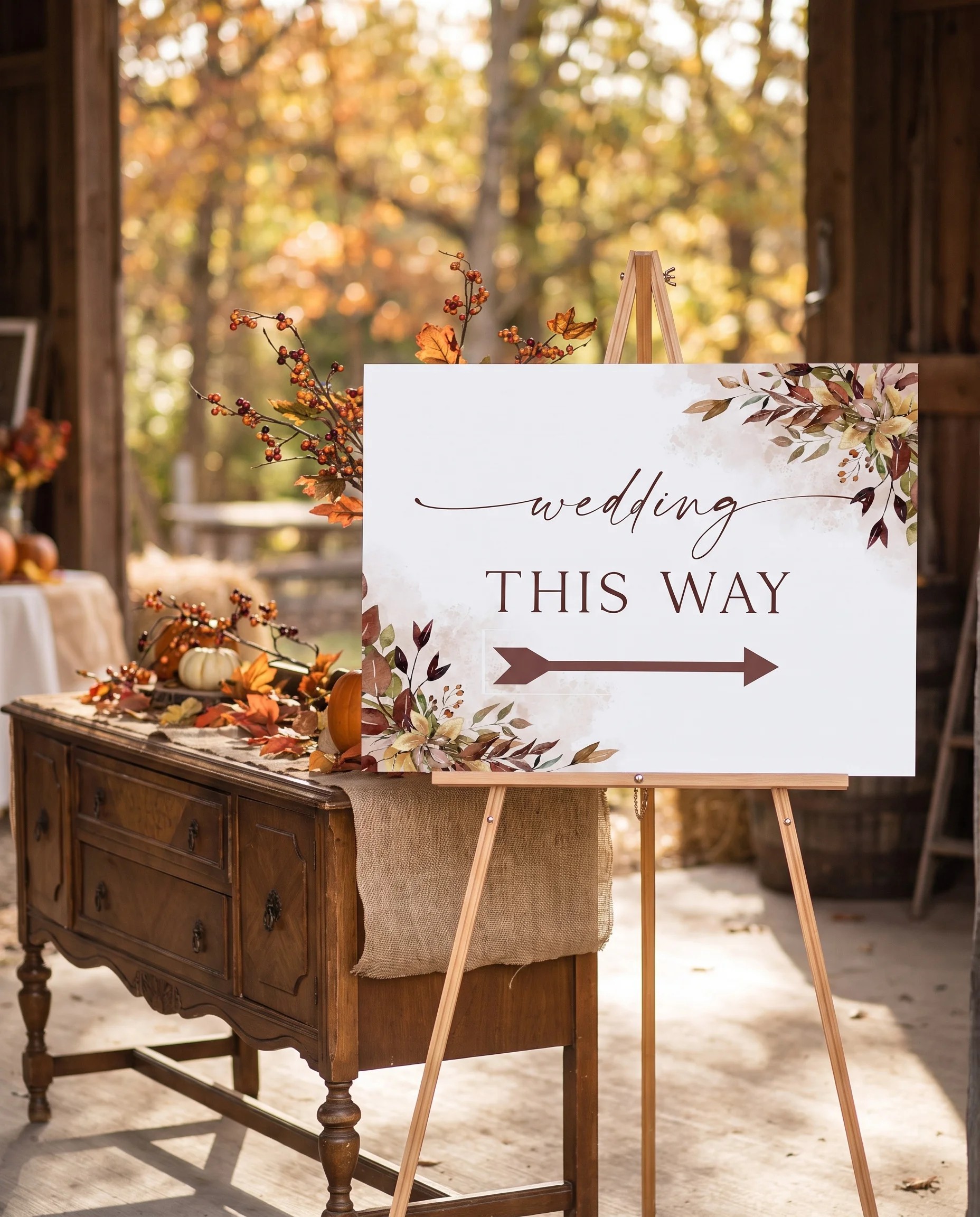 Autumn Bough wedding directional sign — shown beside furniture for scale on premium editorial paper under soft natural light, printable wedding signs.