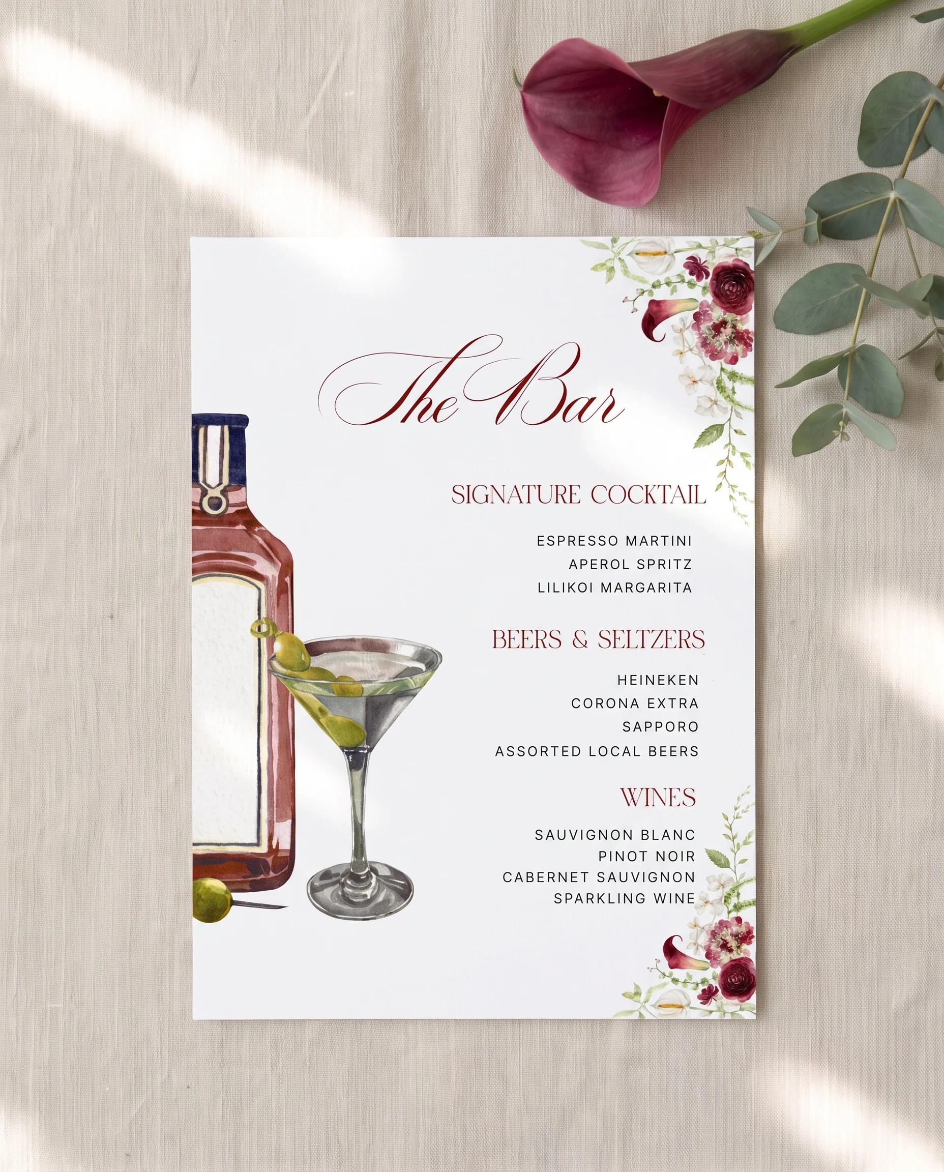 Burgundy Calla — bar menu page lying flat on premium editorial paper under soft natural light, wedding bar menu.