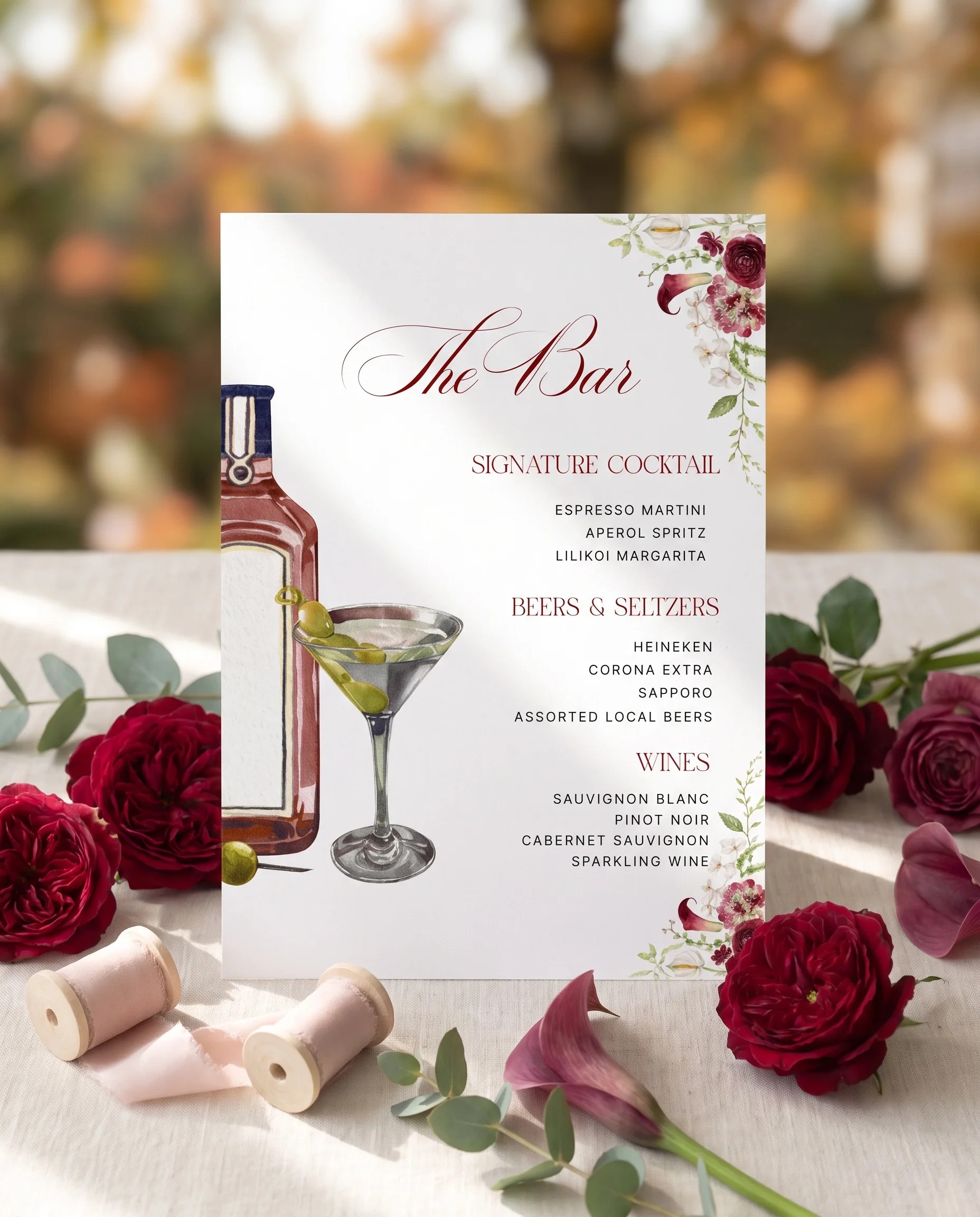 Burgundy Calla — bar menu page displayed upright in a styled setting under soft natural light, wedding bar sign.