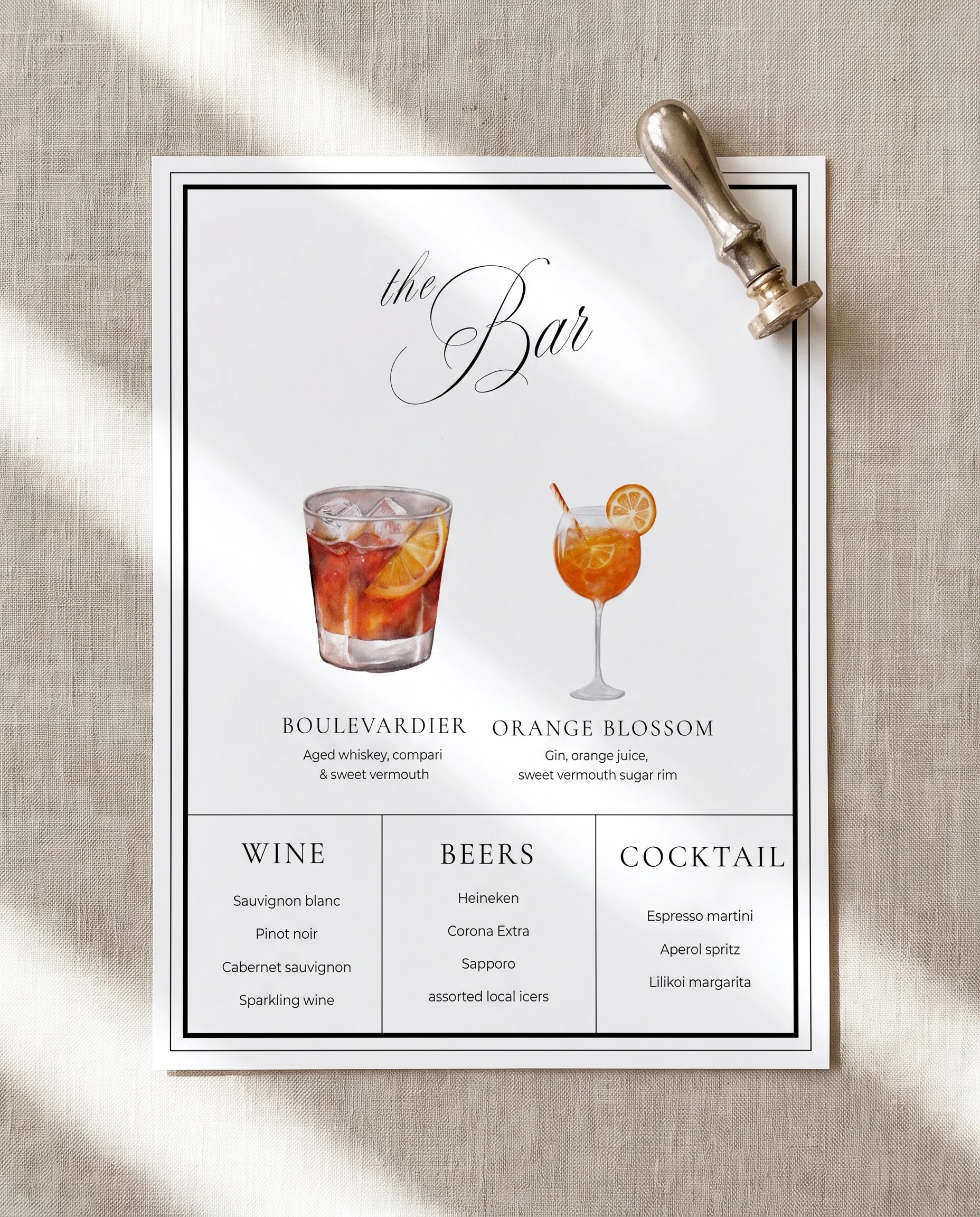 Heirloom — flat lay of the single-page bar menu on premium editorial paper under soft natural light, wedding bar menu.