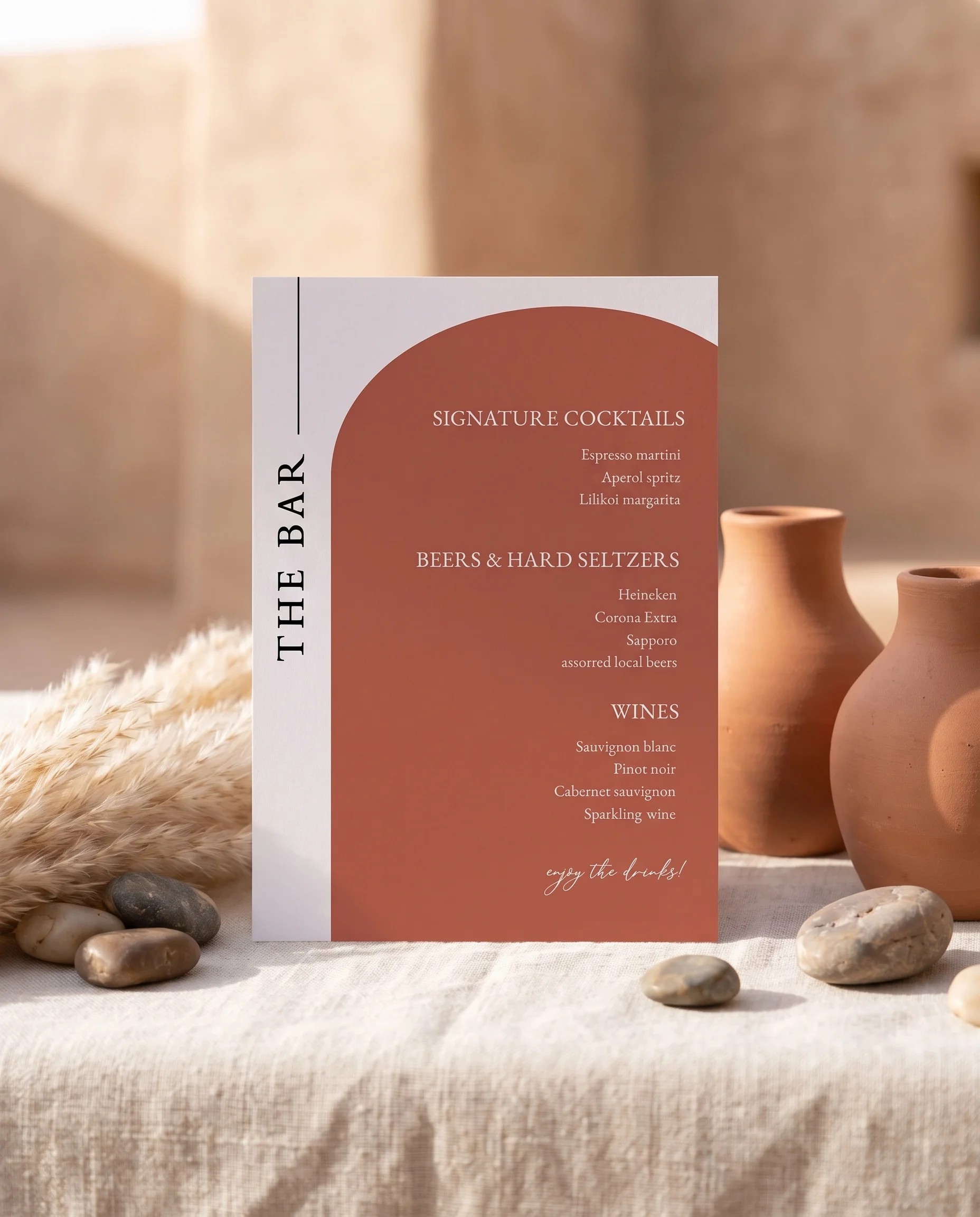 Desert Bloom — bar menu page displayed upright in a styled setting under soft natural light, wedding bar sign.