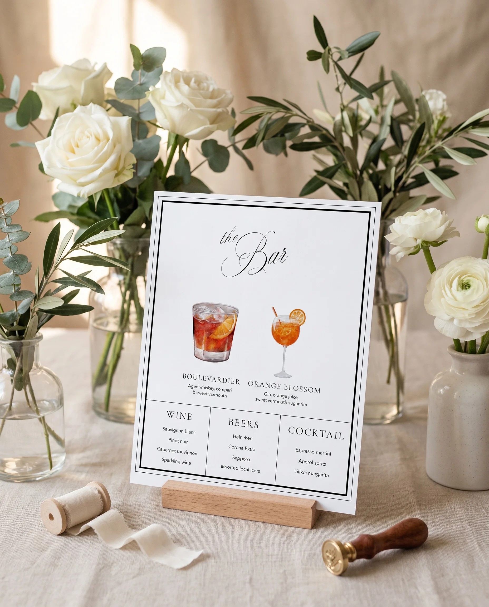 Heirloom — Bar Menu displayed upright in a styled setting under soft natural light, wedding bar sign.