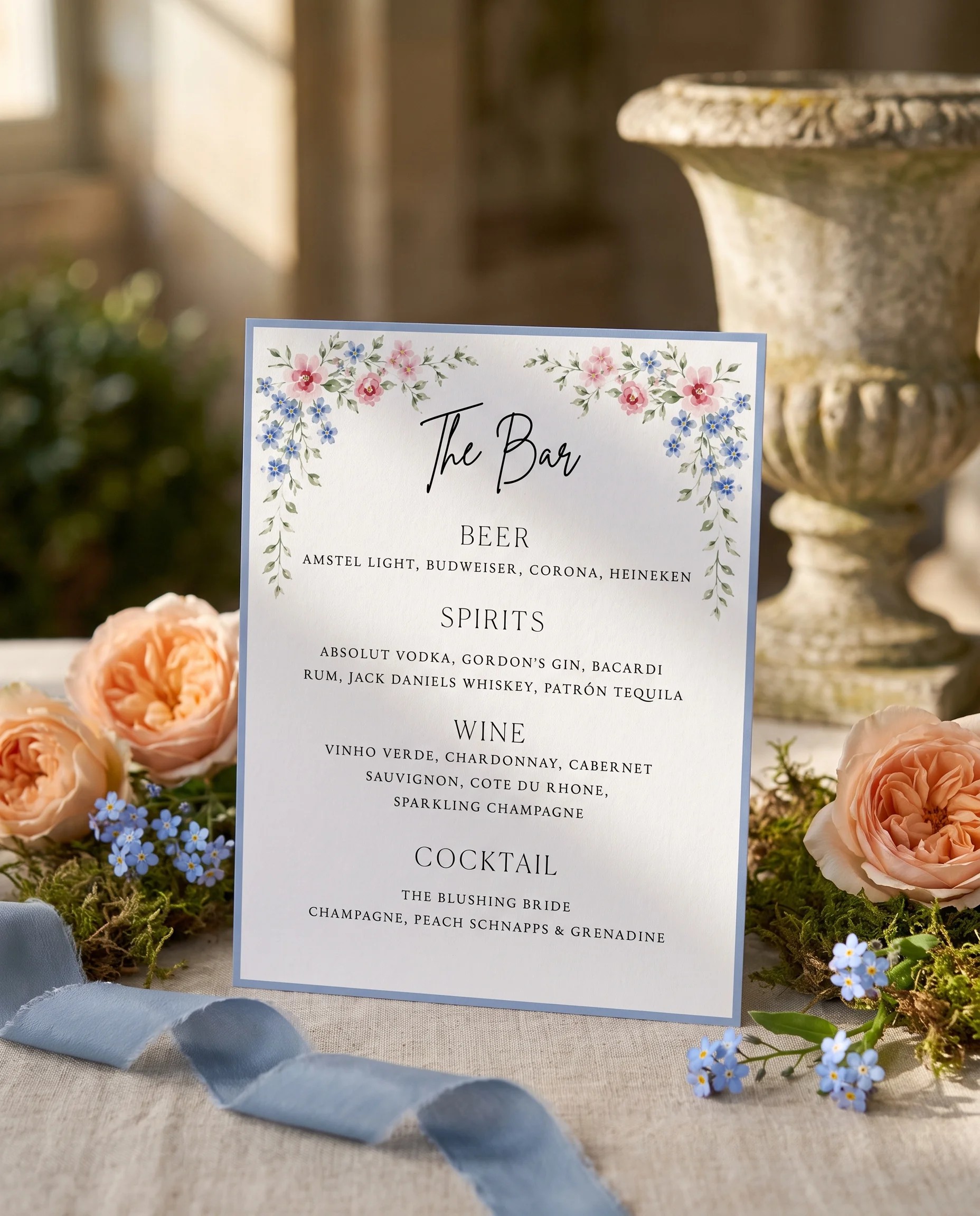 Meadow Spire — bar menu page displayed upright in a styled setting under soft natural light, wedding bar sign.