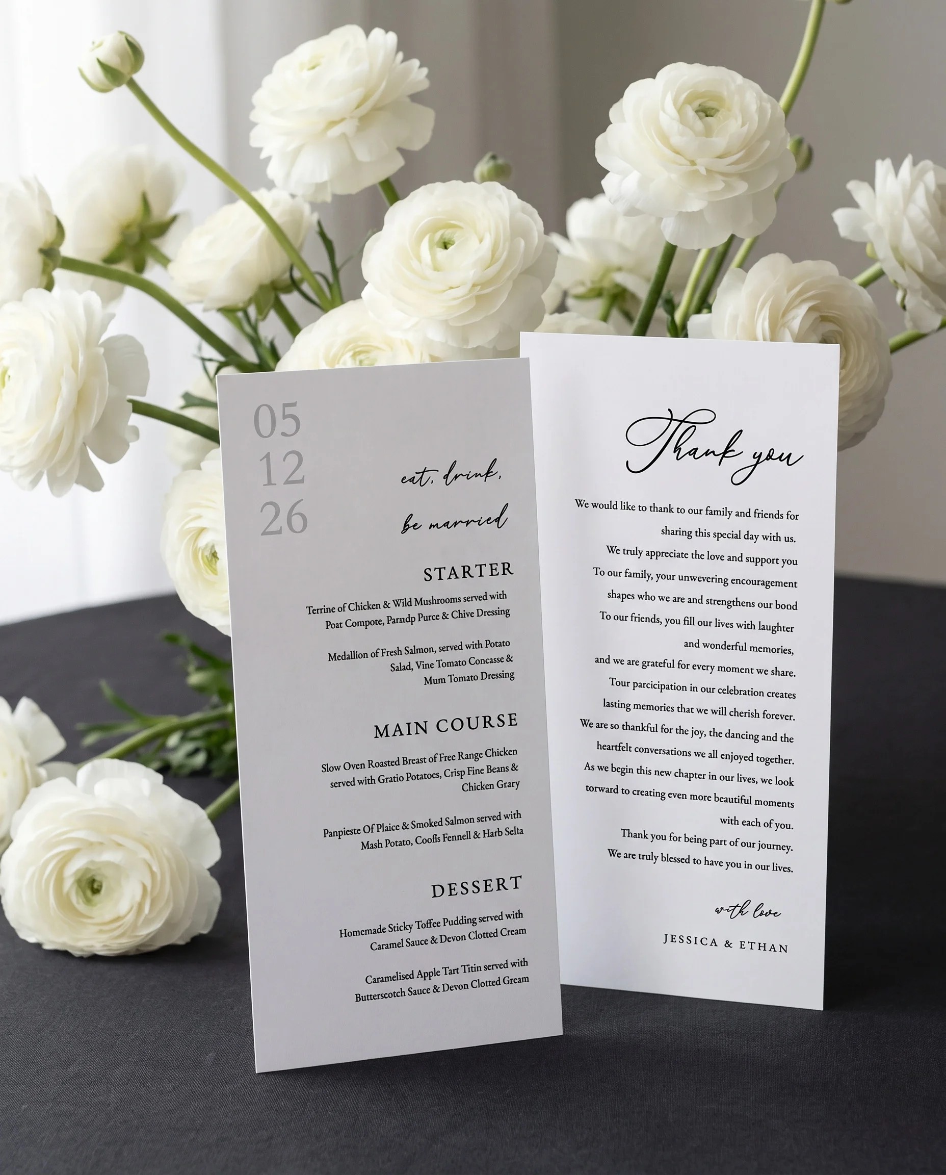 Monochrome Veil wedding menu — two-page monochrome menu standing upright on a reception table under soft natural light, wedding menu template.