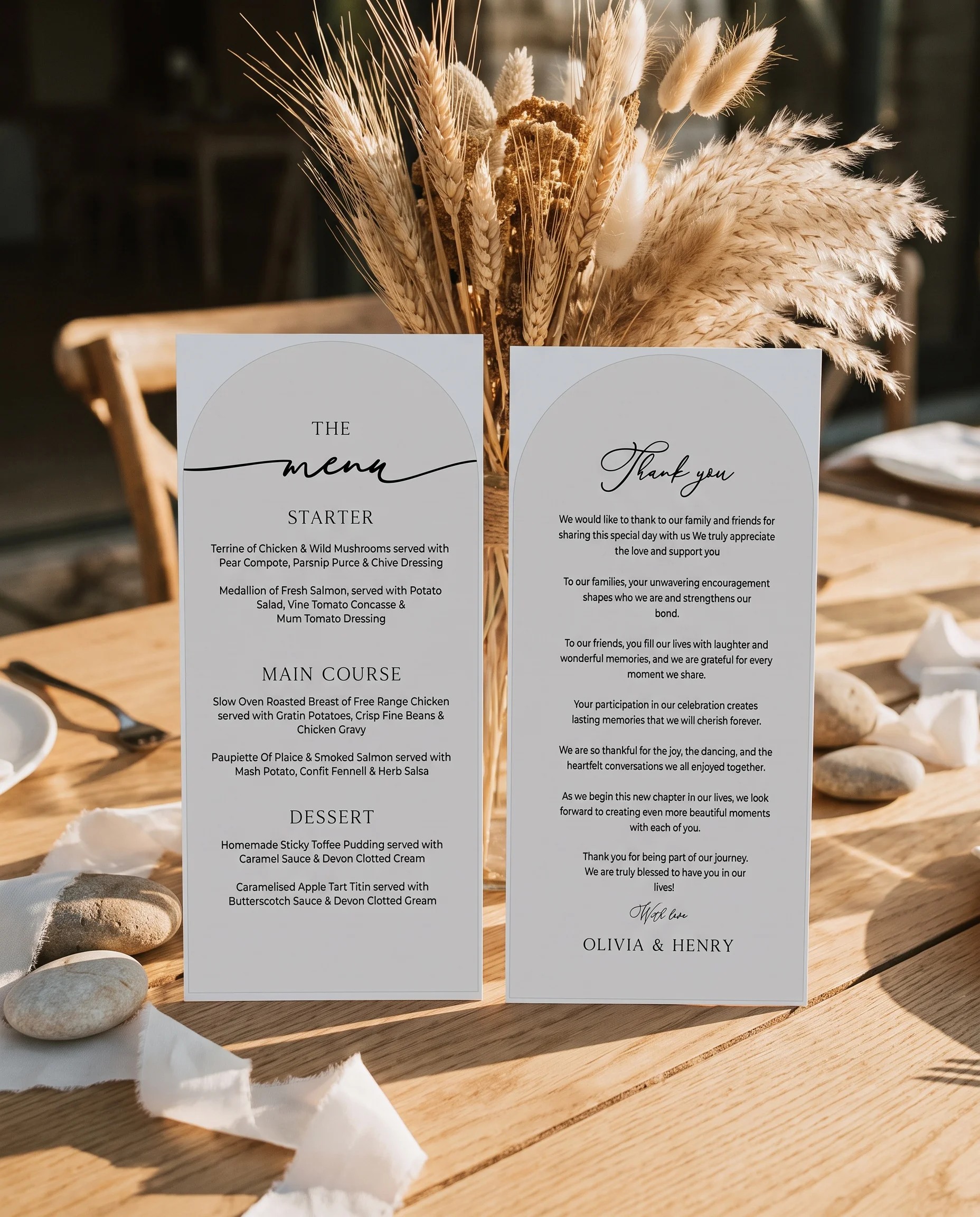 Halo Arch wedding menu — two menu pages standing upright on a reception table under soft natural light, wedding menu template
