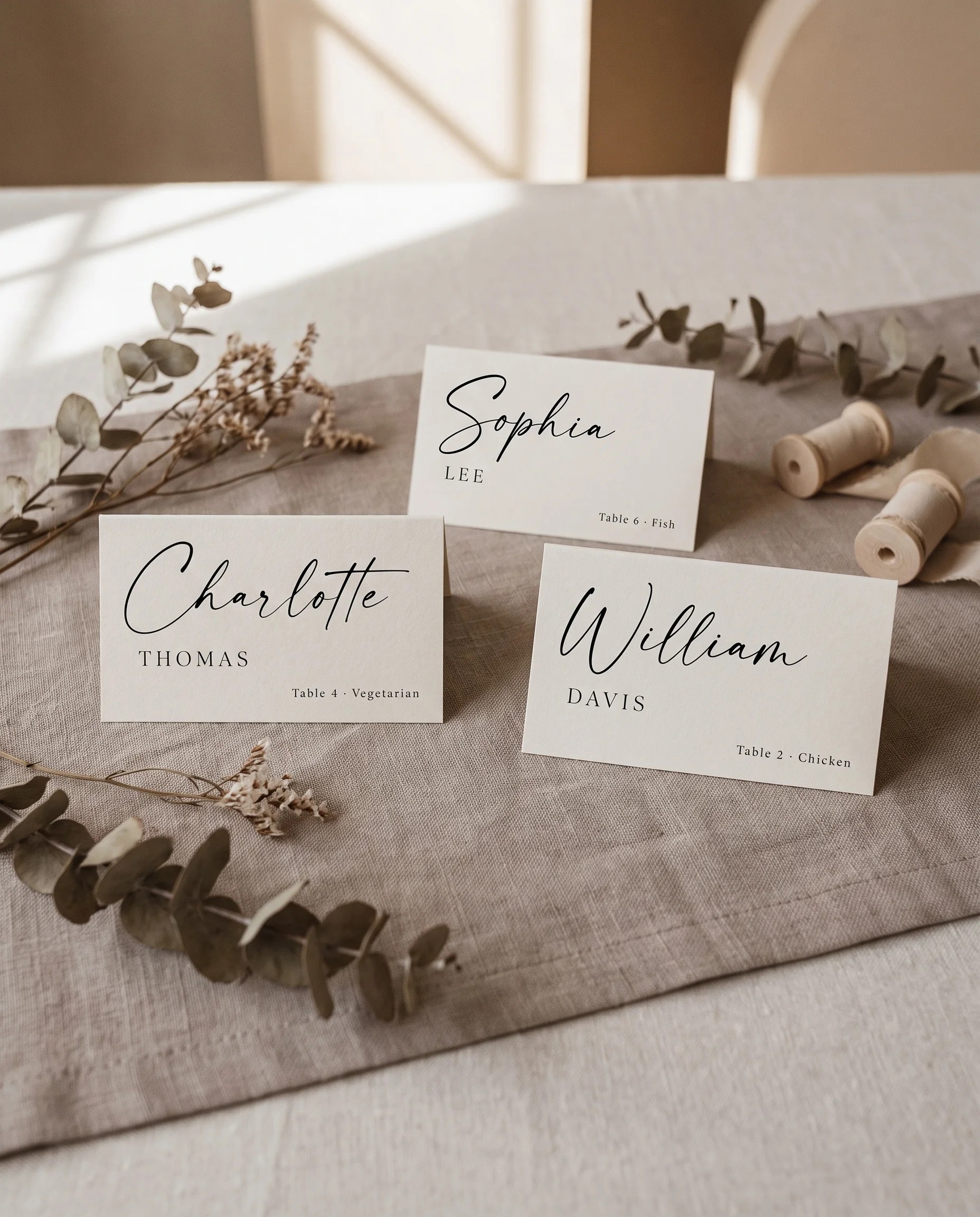 Charline wedding place cards — several place cards displayed on a dressed reception table under soft natural light, place card template