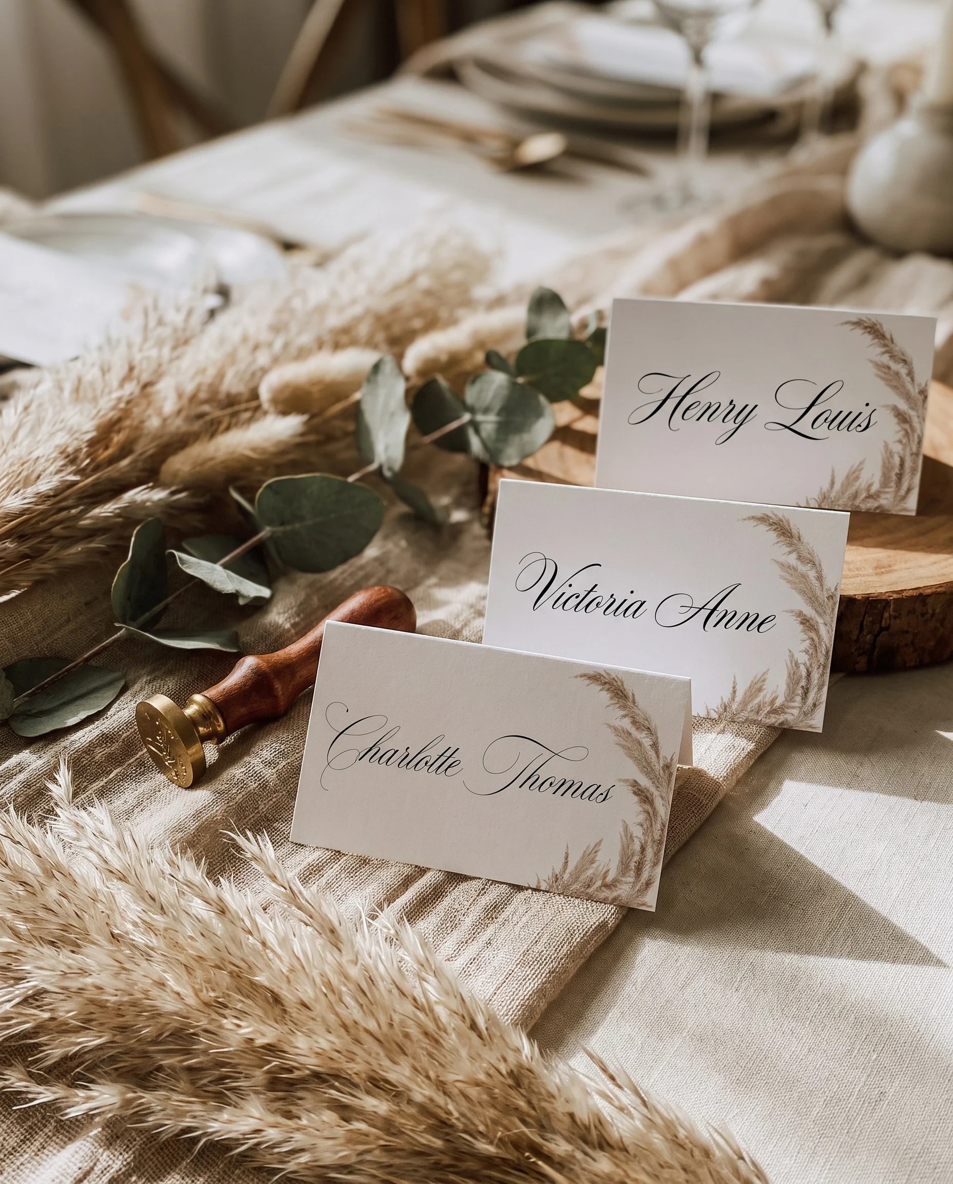 Pampas wedding place cards — cards arranged on a dressed reception table under soft natural light, slight overhead angle, place card template.