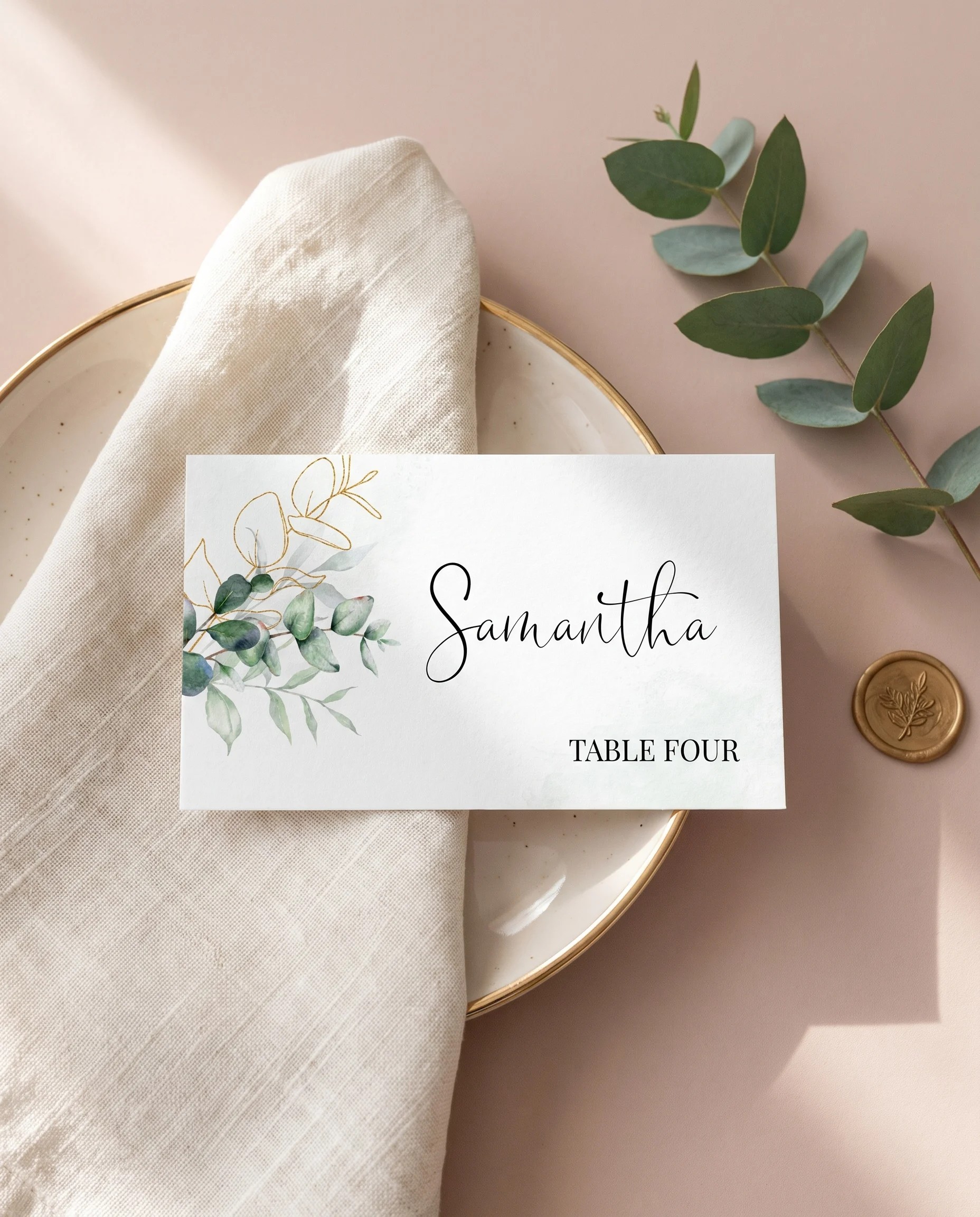 Eucalyptus gold wedding place cards — a card at a set place setting under soft natural light, wedding name cards.