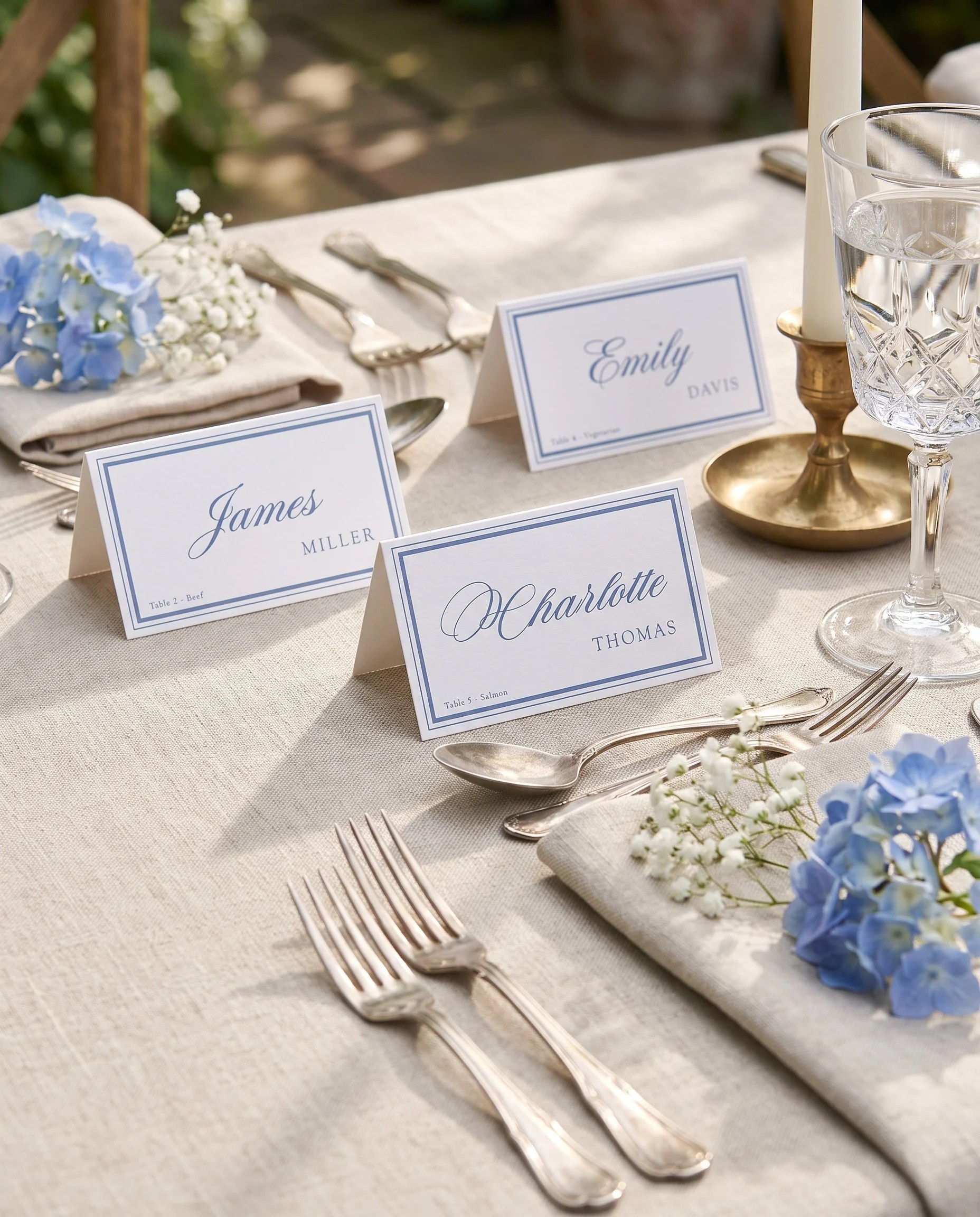Azure Flourish wedding place cards — cards arranged on a dressed reception table under soft natural light, place card template.