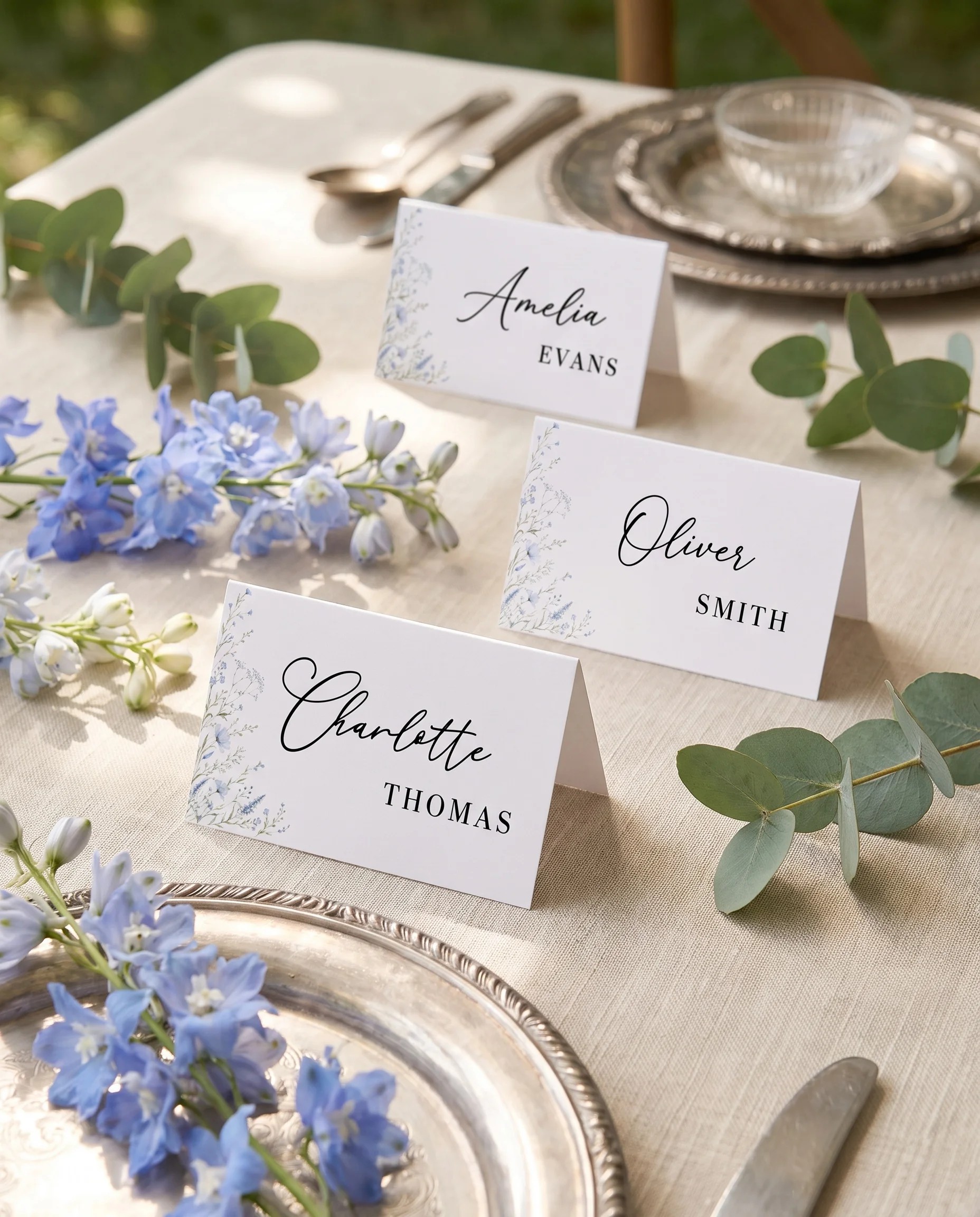 Azure Sprig wedding place cards — cards arranged on a dressed reception table under soft natural light, place card template.