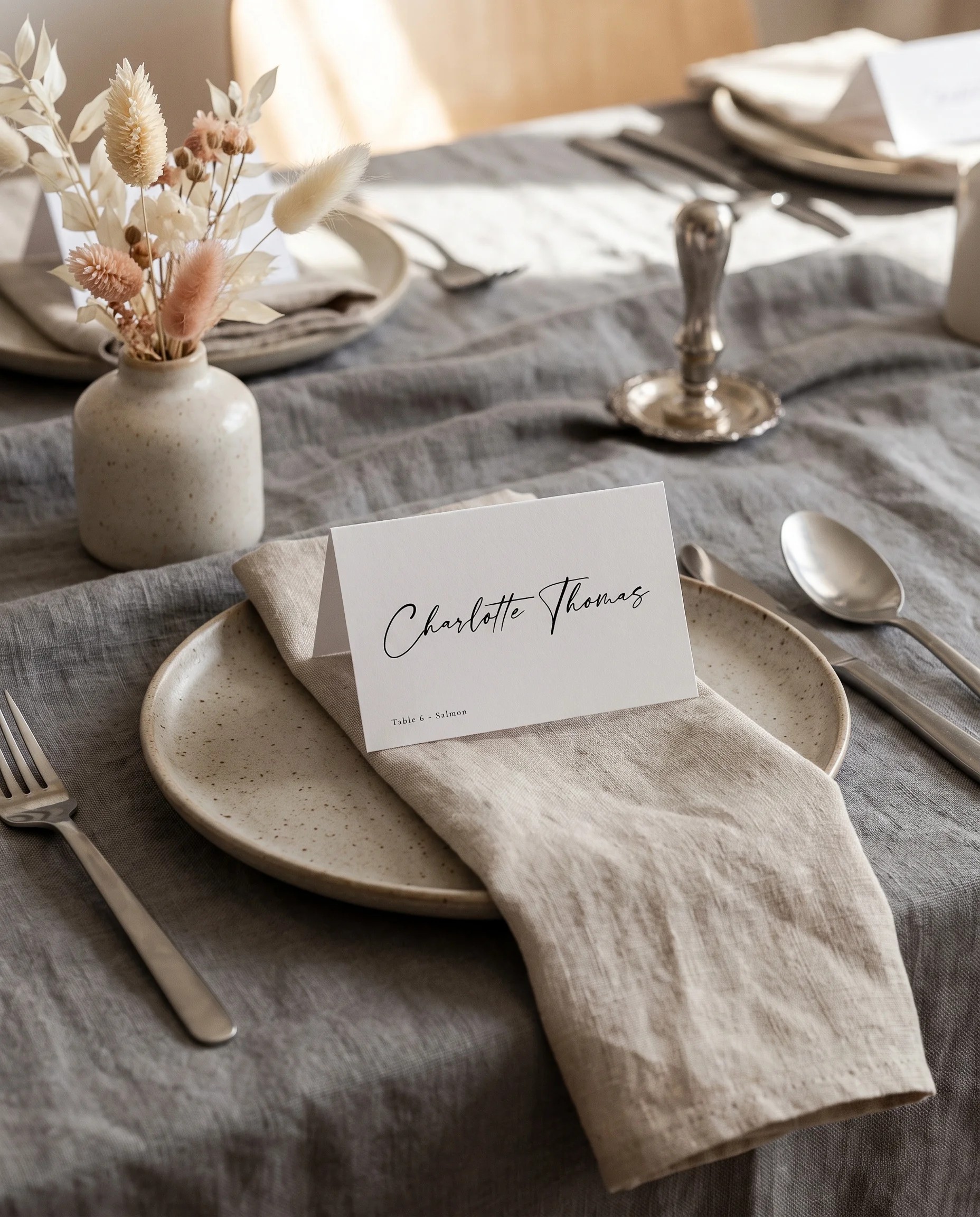 Tonal Reply wedding place cards — single card displayed at a set table place setting under soft natural light, wedding name cards