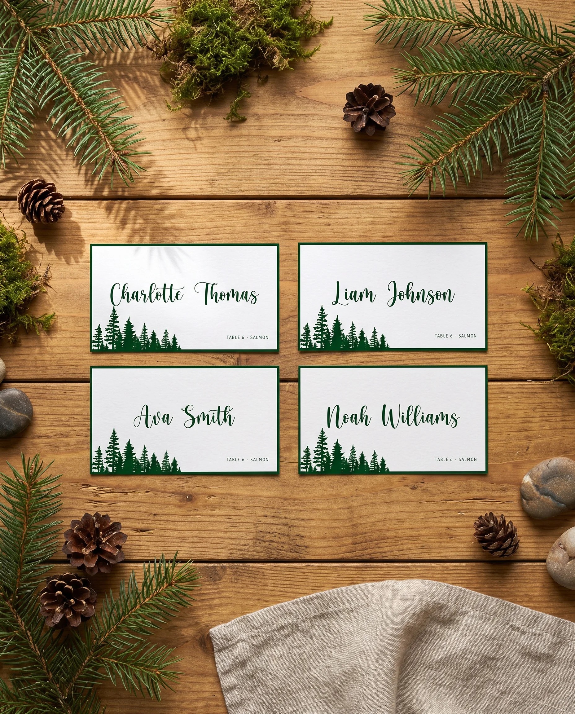 Evergreen Star wedding place cards — several place cards shown flat under soft natural light, overhead angle, wedding place cards