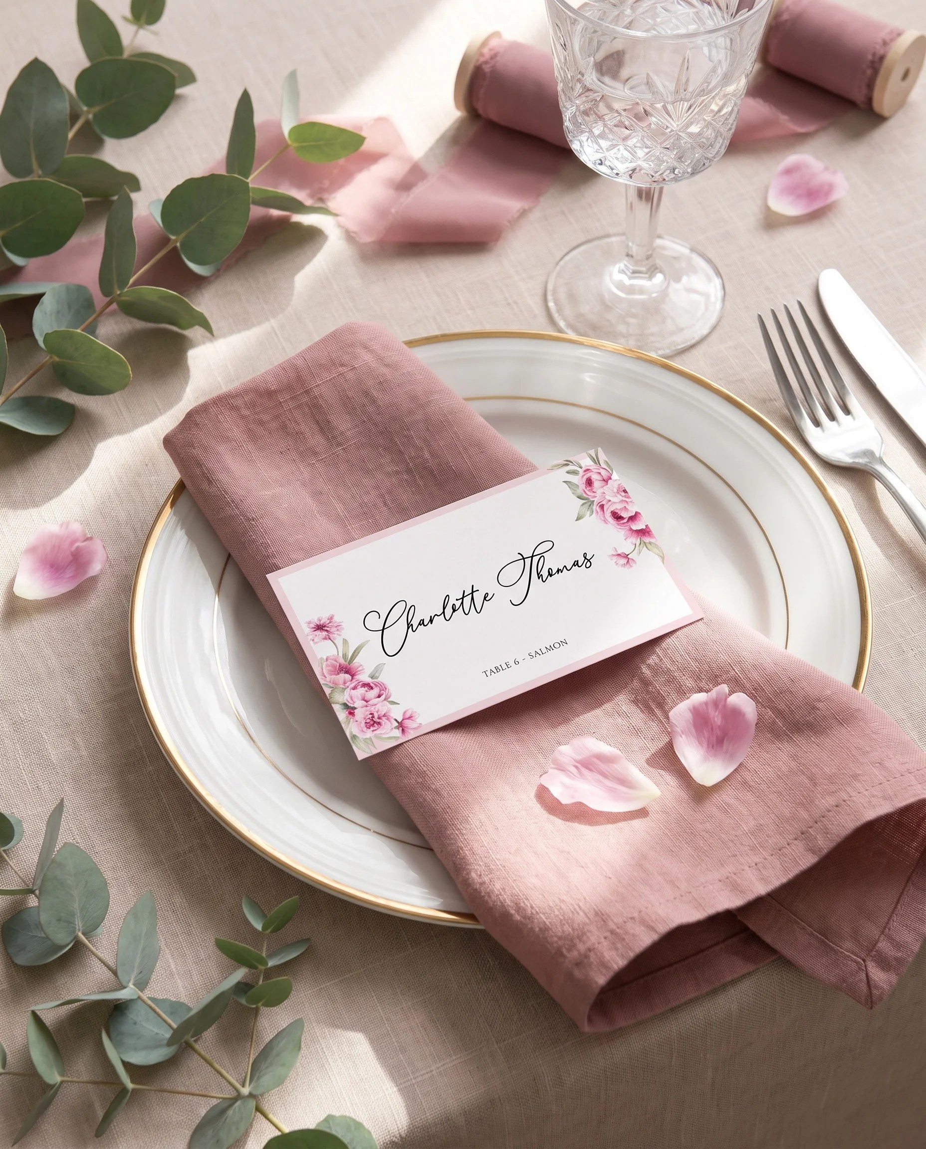 Blush Peony wedding place cards — a single card at a set place setting under soft overhead light, wedding name cards.