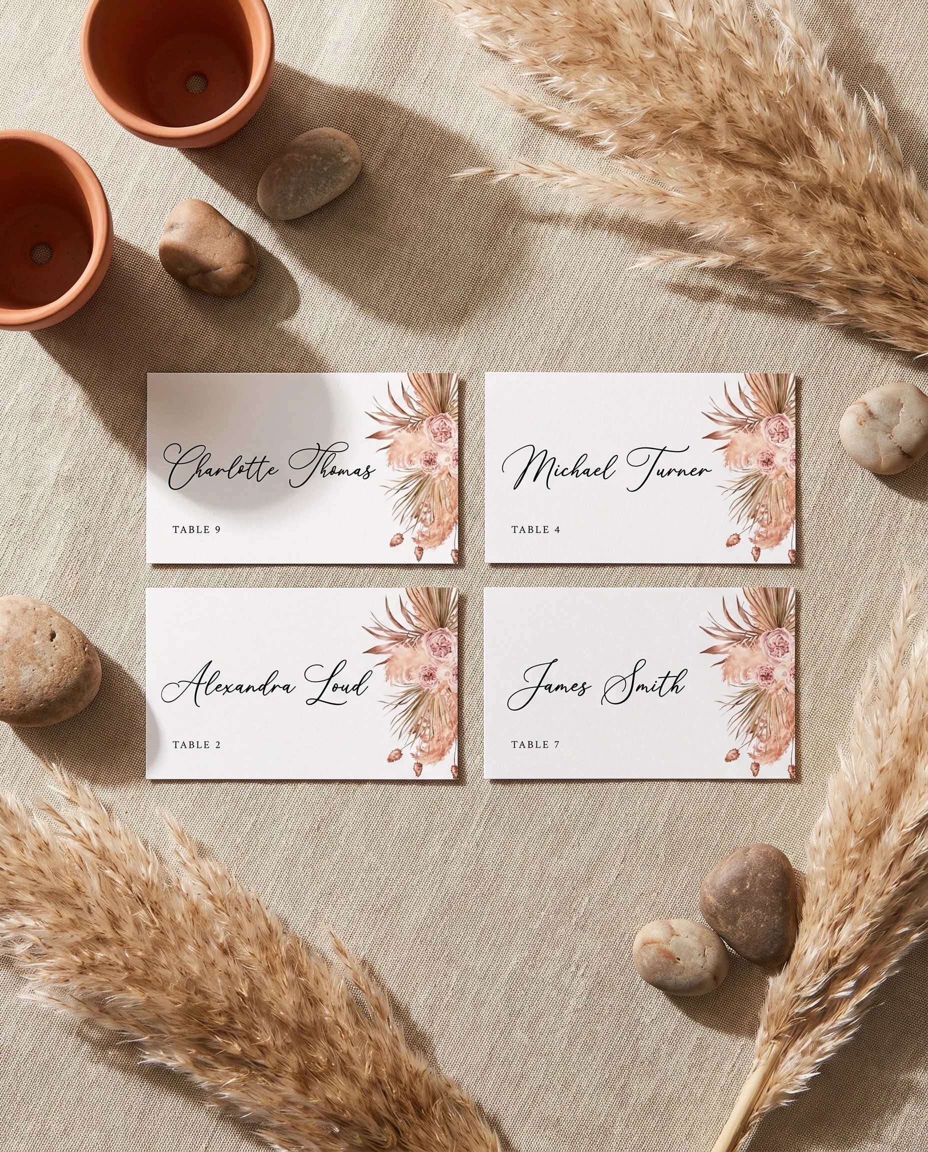 Desert Bloom wedding place cards — several cards shown flat under soft natural light at a slight overhead angle, wedding place cards.