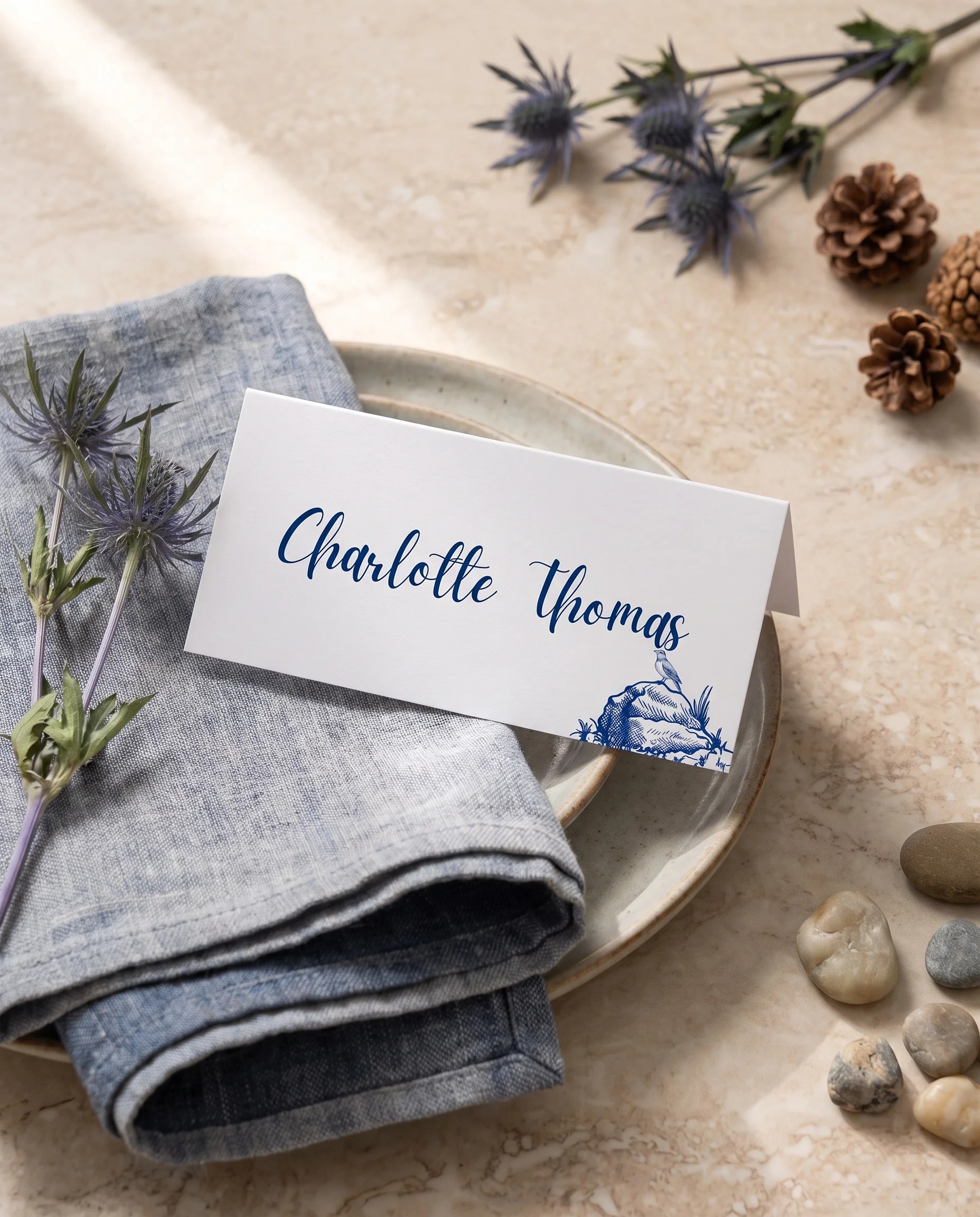 Blue Range wedding place cards — a single card at a set place setting under soft natural light, wedding name cards