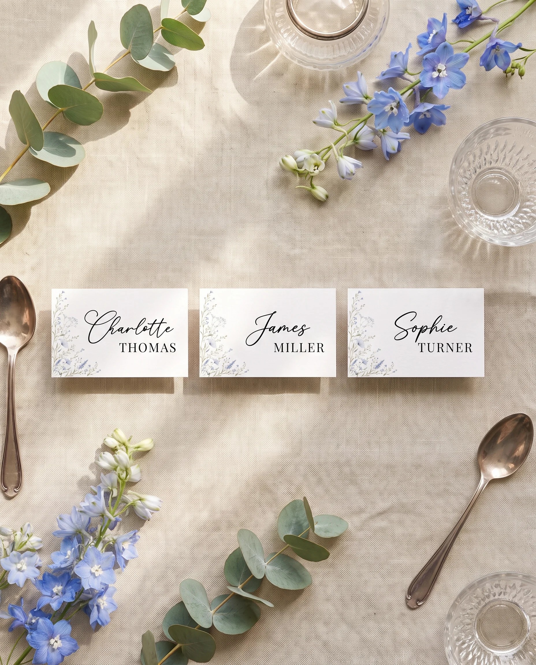Azure Sprig wedding place cards — several place cards shown flat under soft natural light, overhead editorial view, wedding place cards.