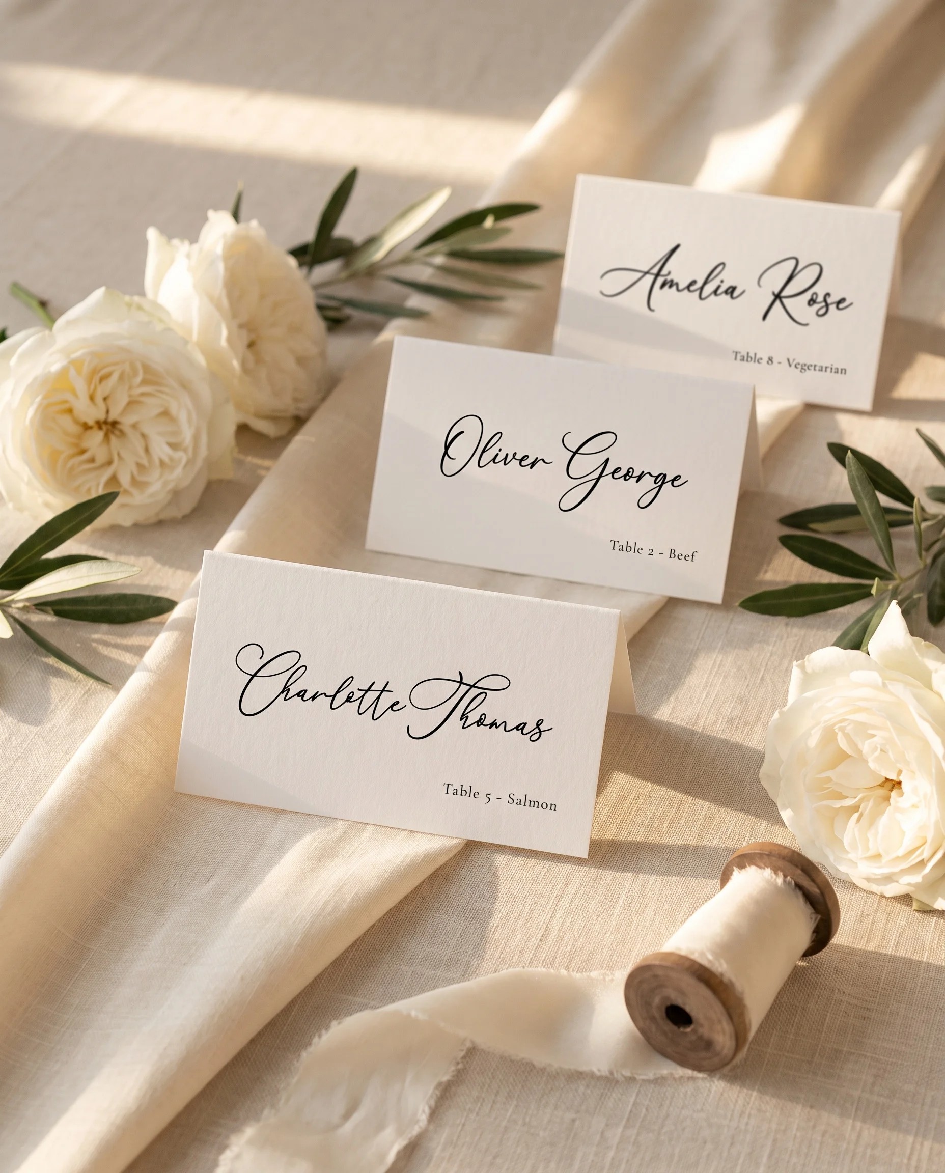 Quiet Line wedding place cards — several cards arranged on a dressed reception table under soft natural light, place card template