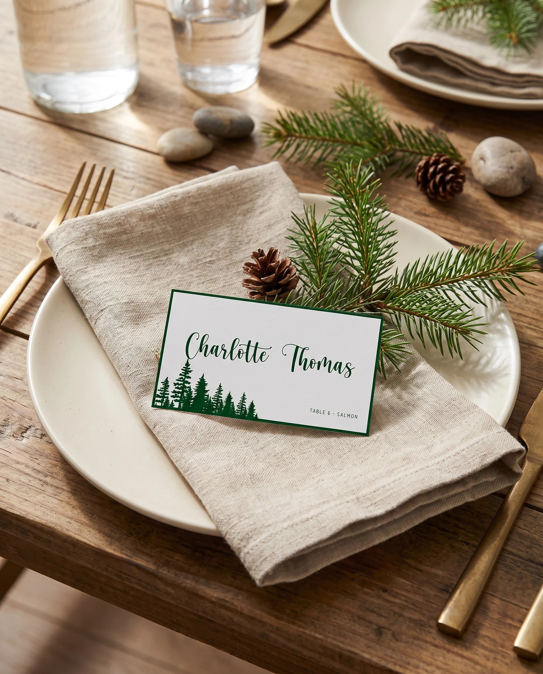 Evergreen Star wedding place cards — a single card displayed at a set place setting under soft overhead light, wedding name cards.